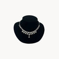 Art Deco style rhodium plated crystal fringe necklace on black bust.