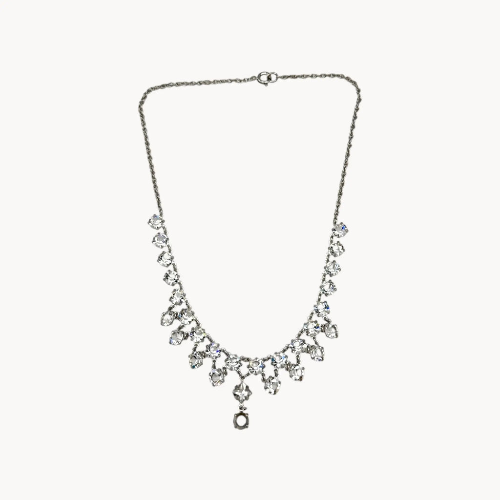 Art Deco style rhodium plated crystal fringe necklace on white background.