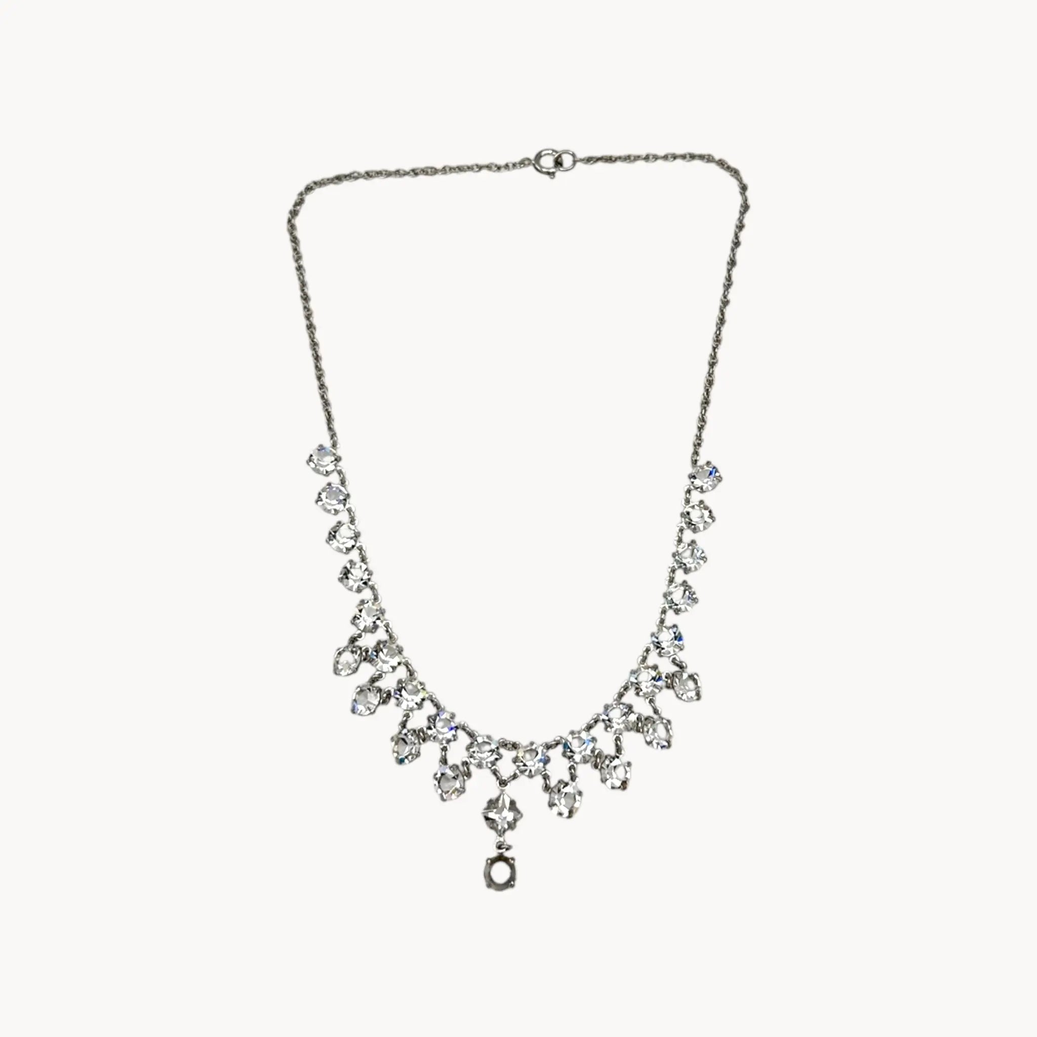 Art Deco style rhodium plated crystal fringe necklace on white background.