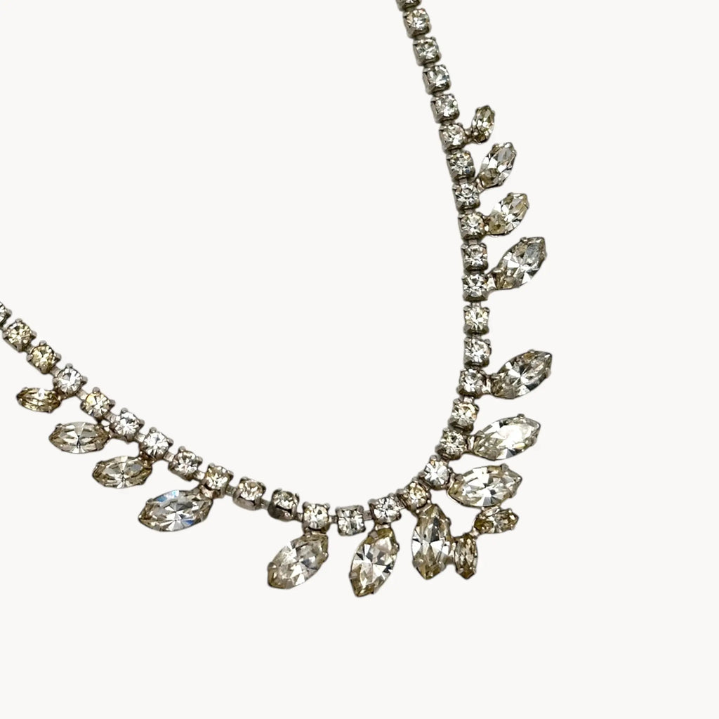 Close up view of pendant of 1950s B. David rhinestone necklace with round and marquise stones in garland design, vintage bridal jewelry.