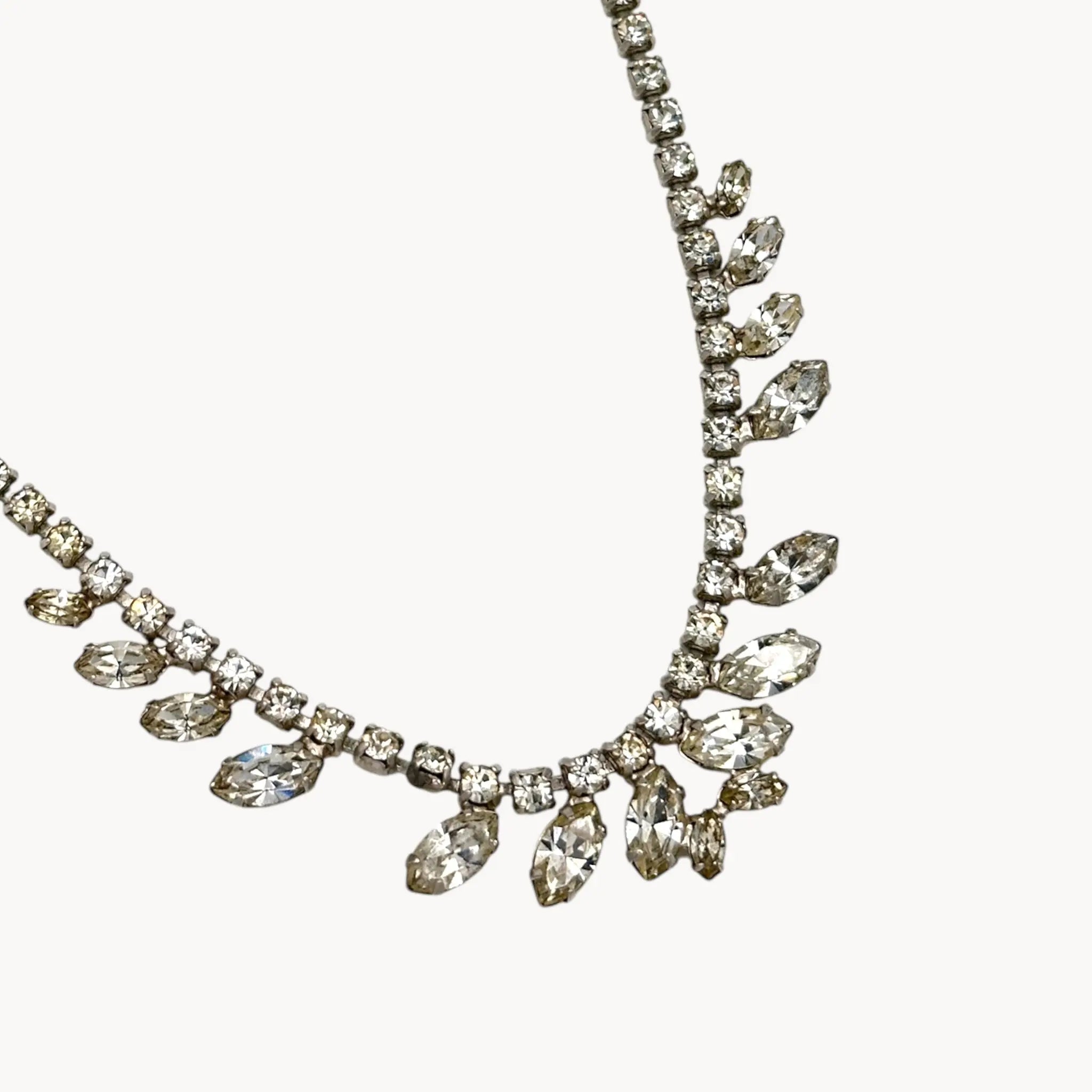 Close up view of pendant of 1950s B. David rhinestone necklace with round and marquise stones in garland design, vintage bridal jewelry.