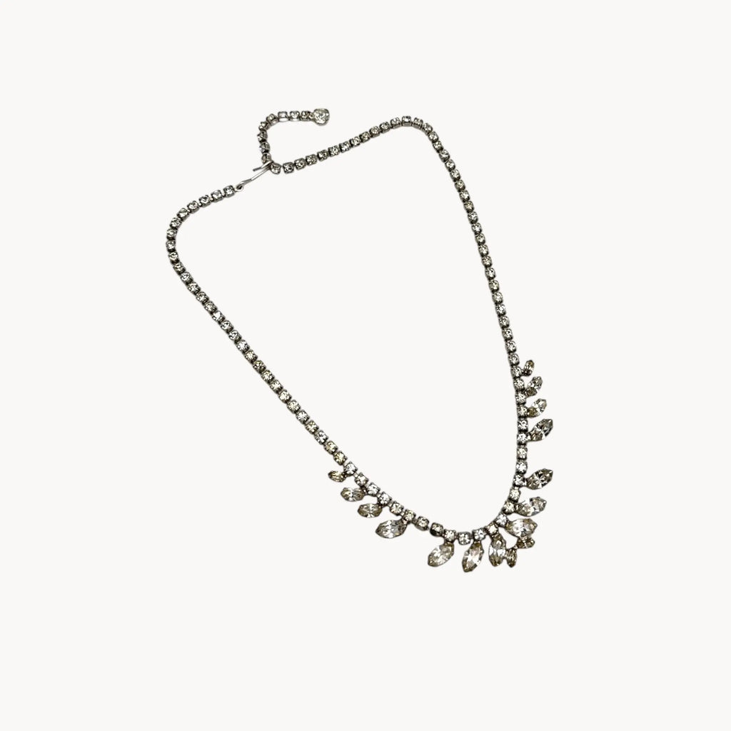 View against white of 1950s B. David rhinestone necklace with round and marquise stones in garland design, vintage bridal jewelry.