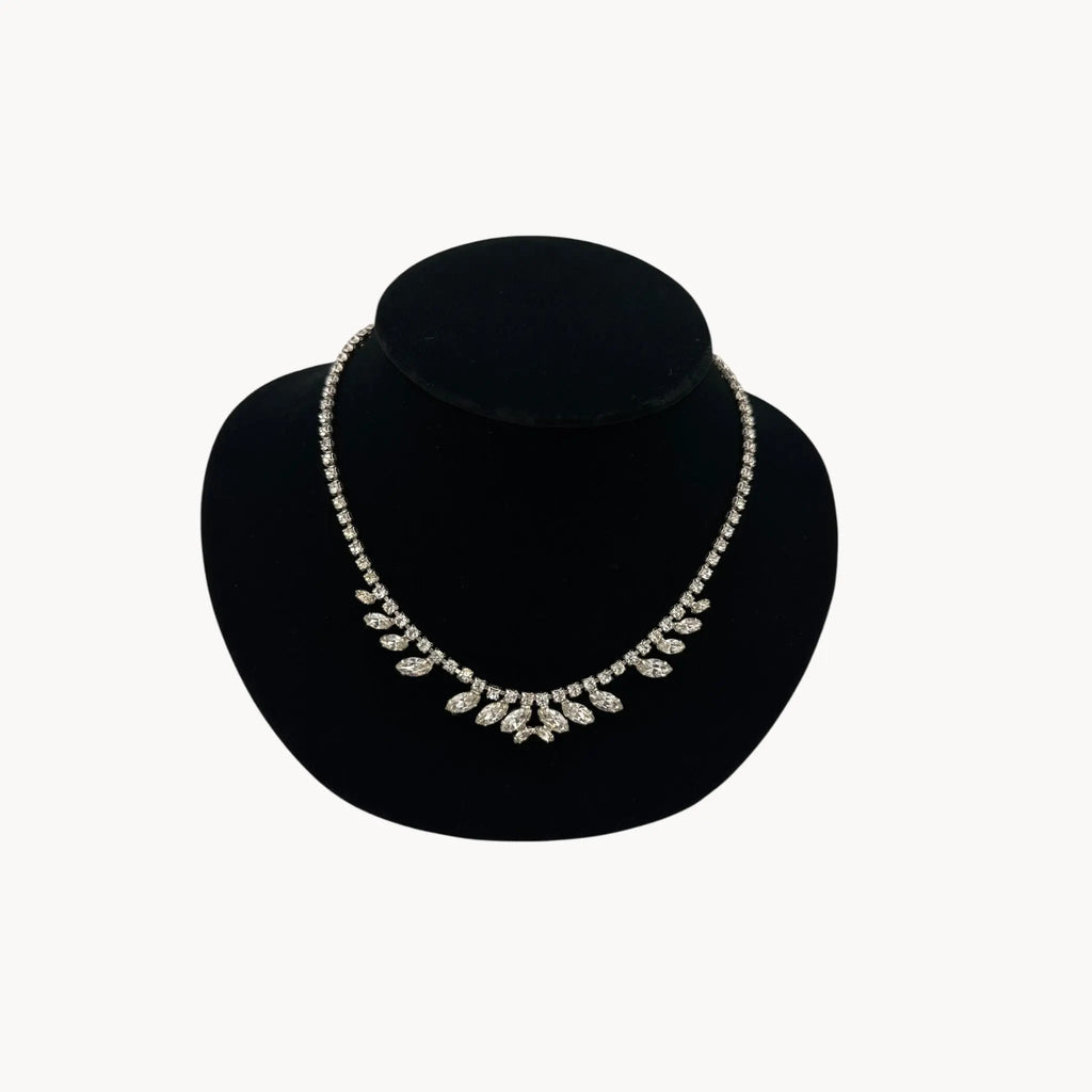 Close up view of 1950s B. David rhinestone necklace with round and marquise stones in garland design, vintage bridal jewelry.