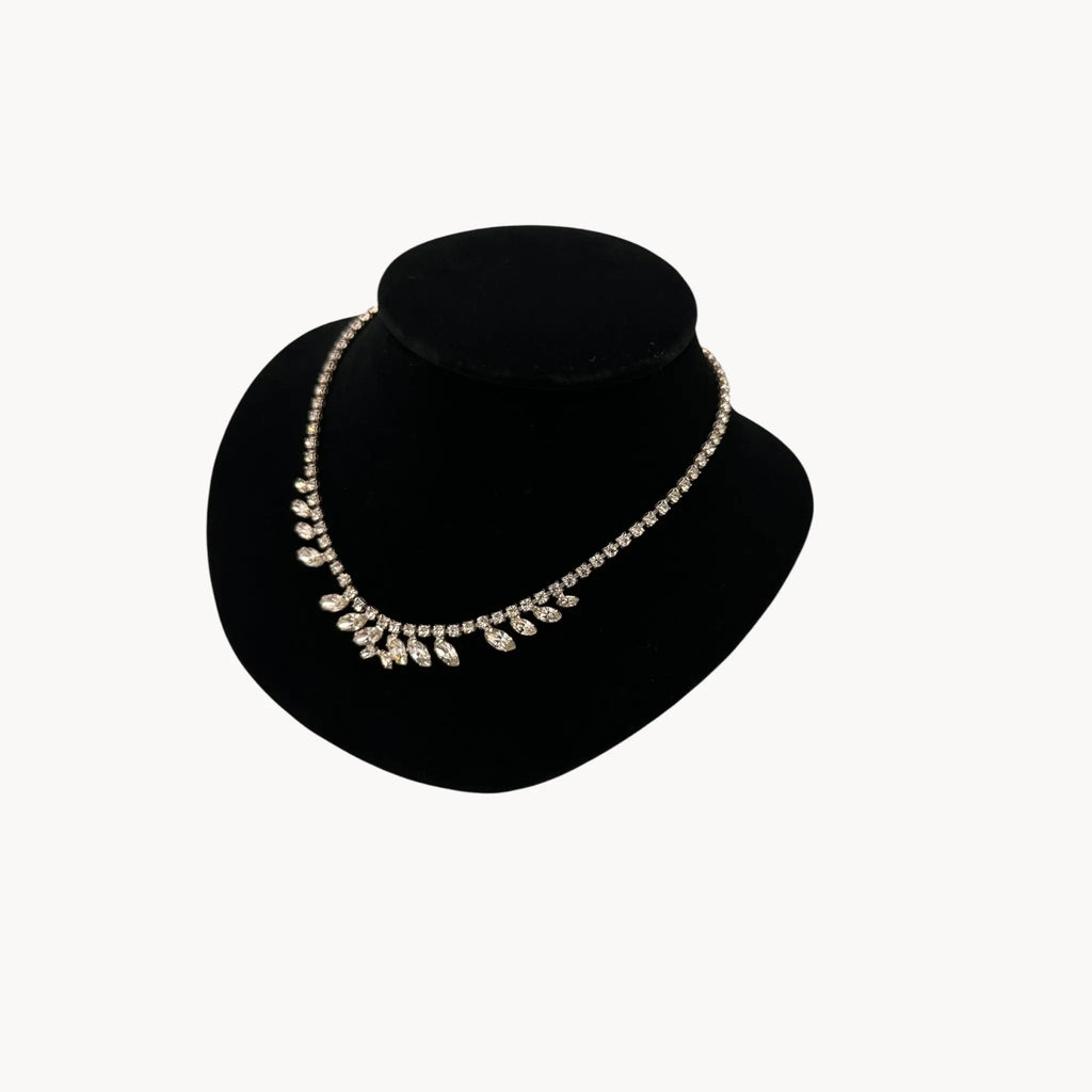 Side view of 1950s B. David rhinestone necklace with round and marquise stones in garland design, vintage bridal jewelry.