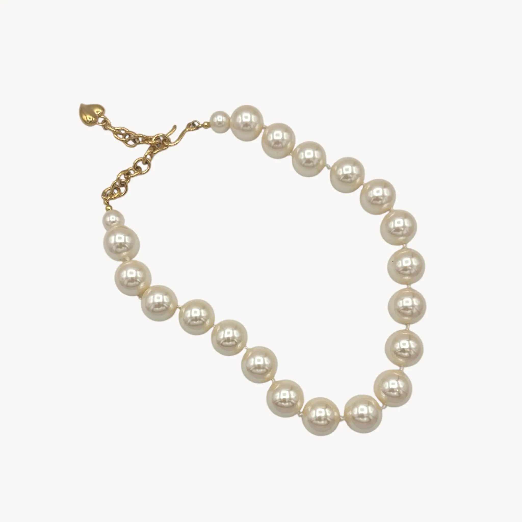 Carolee statement faux pearl strand necklace adjustable on white background.