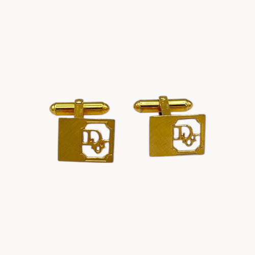 Vintage Christian Dior gold-plated square cufflinks with logo cutout design displayed on white background.