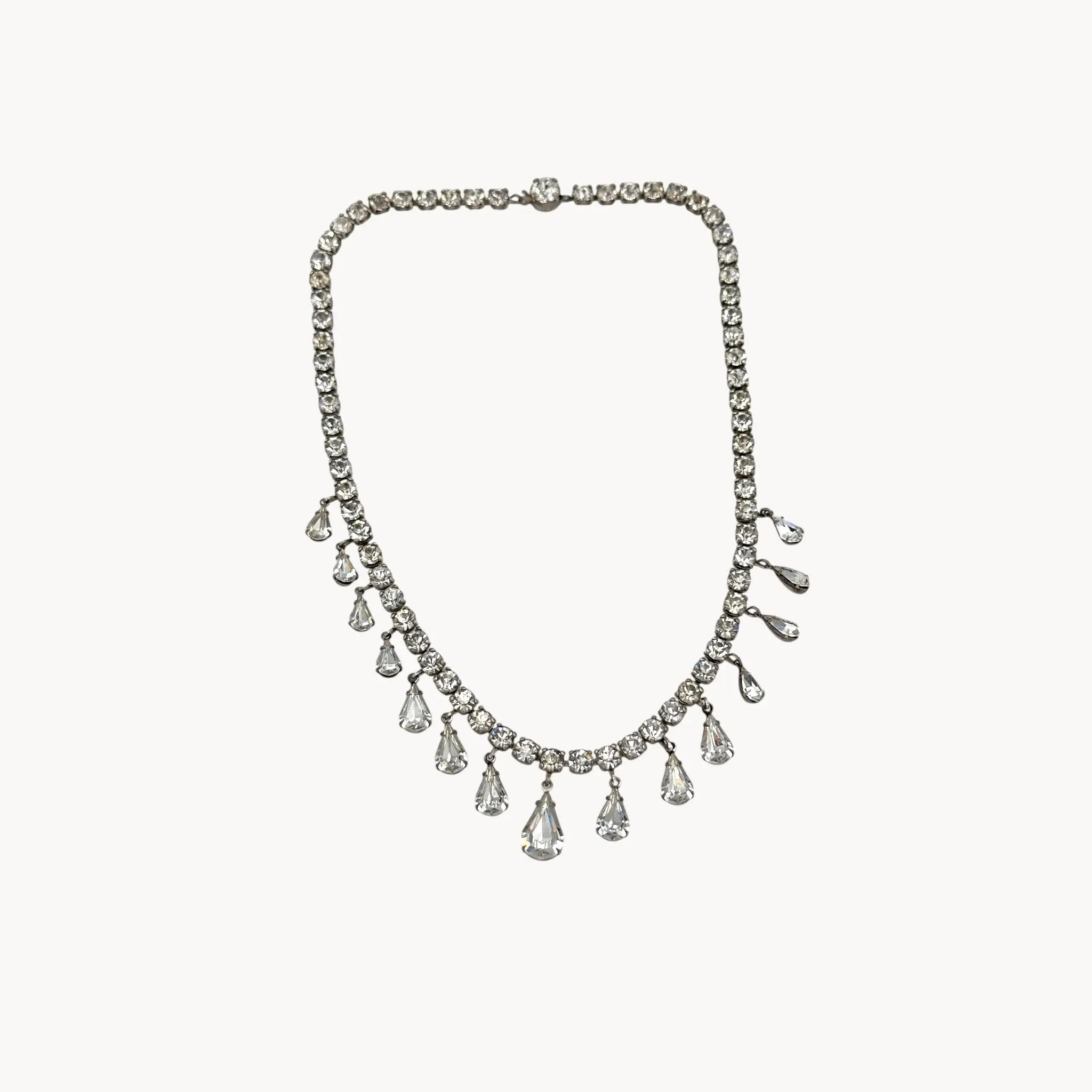 Coro sterling silver Art Deco necklace with teardrop rhinestone pendant on white background.