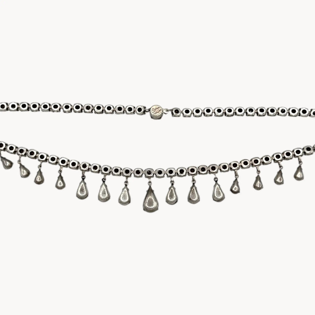 Back view of Coro sterling silver Art Deco necklace with teardrop rhinestone pendant on white background.