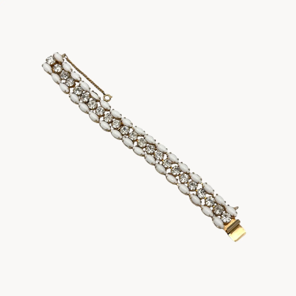 Layout on white background Mid-century Eisenberg bracelet with white milk glass and rhinestones, double-row design.
