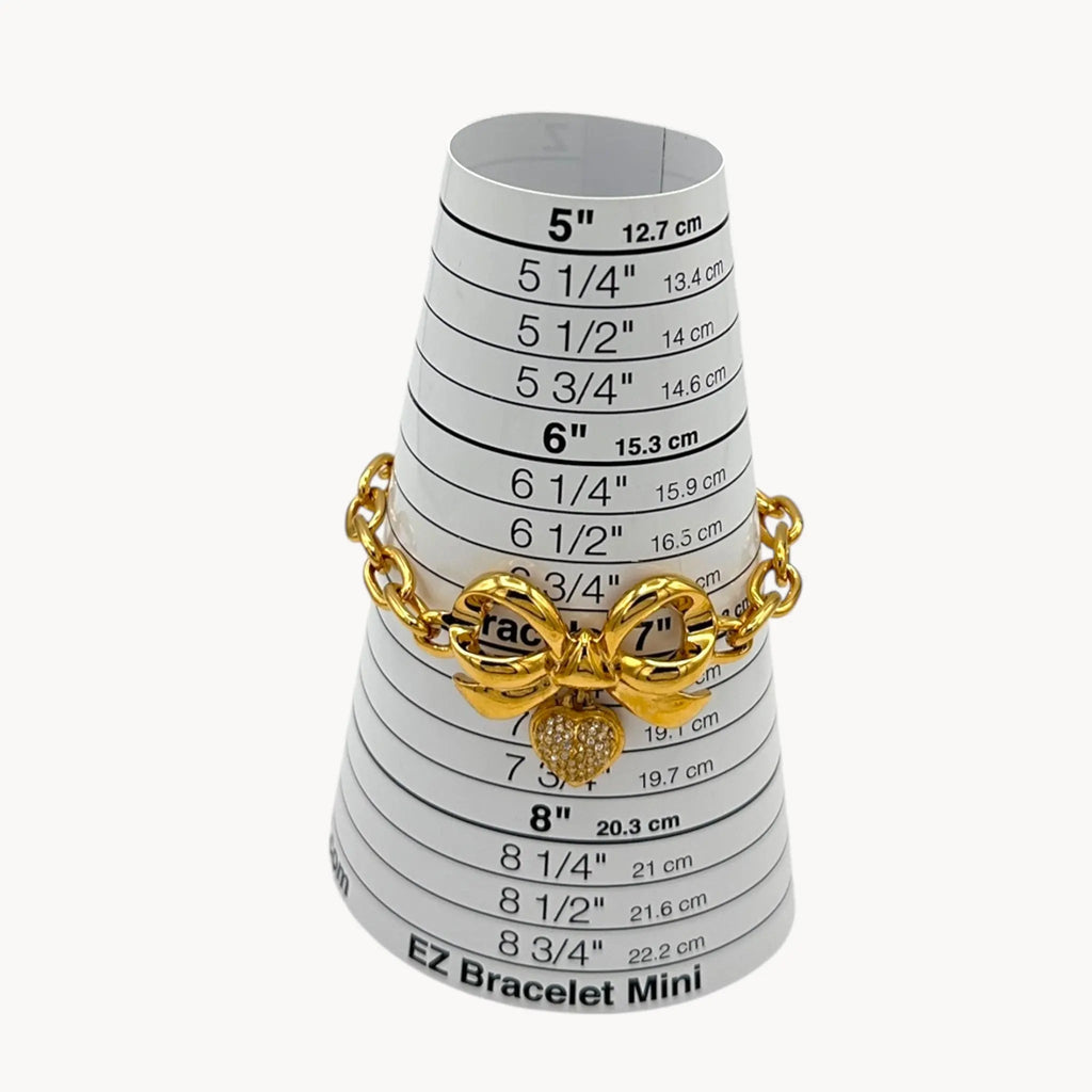 Elizabeth Taylor gold-tone bow and pave heart bracelet on sizer.