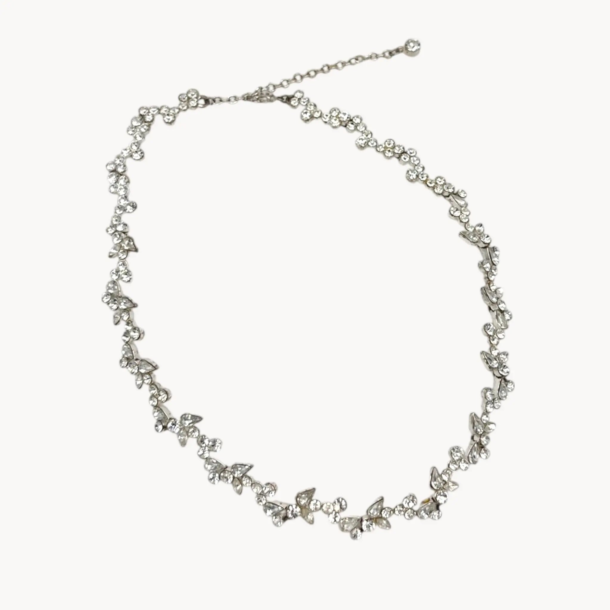 Close up view of Givenchy silver-tone floral crystal rhinestone necklace, vintage bridal jewelry on white background.