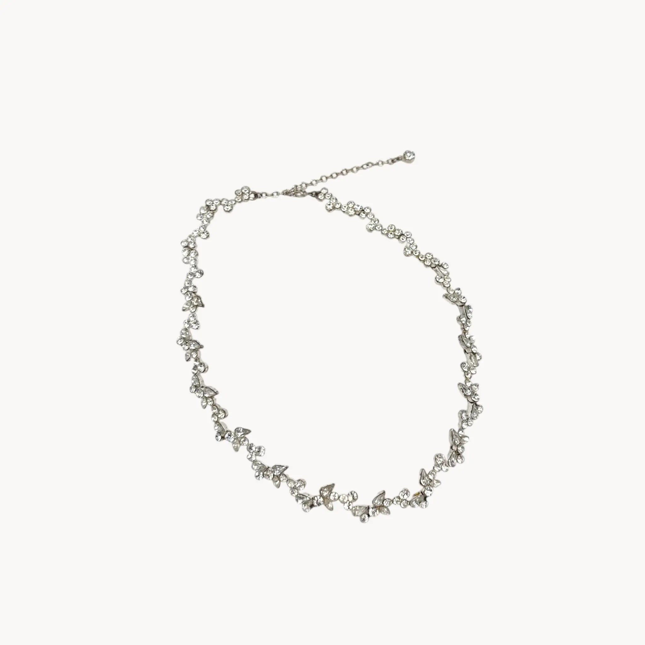 Givenchy silver-tone floral crystal rhinestone necklace, vintage bridal jewelry on white background.