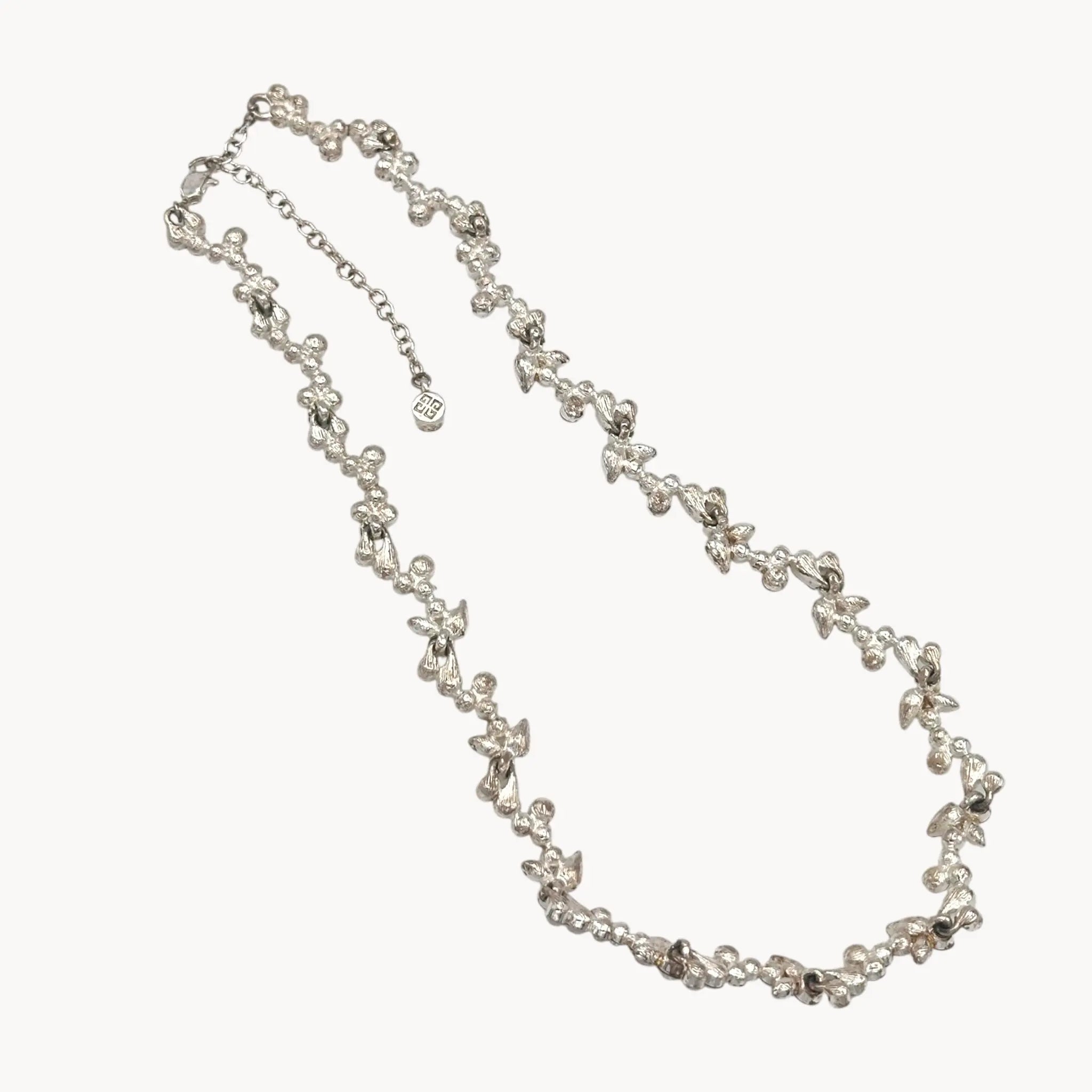 Back view of Givenchy silver-tone floral crystal rhinestone necklace, vintage bridal jewelry on white background.