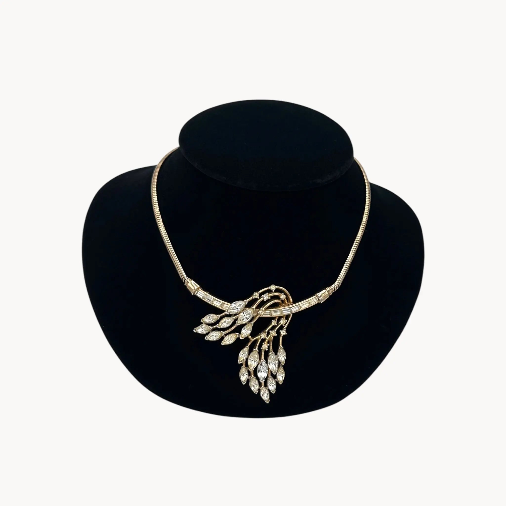 Close up view of 1950s Trifari rhinestone necklace with marquise spray design on snake chain, vintage mid-century bridal jewelry.