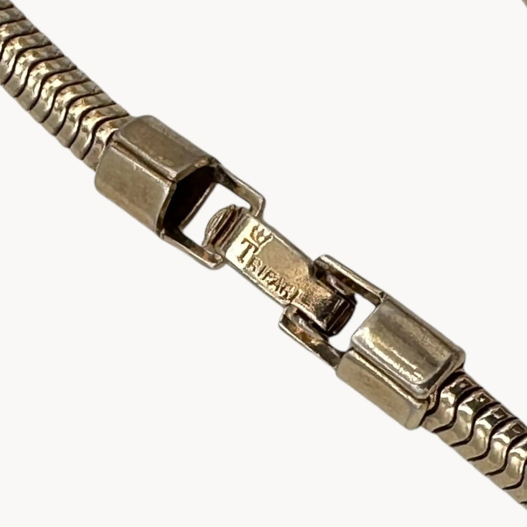 Clasp view of 1950s Trifari rhinestone necklace with marquise spray design on snake chain, vintage mid-century bridal jewelry on white background.