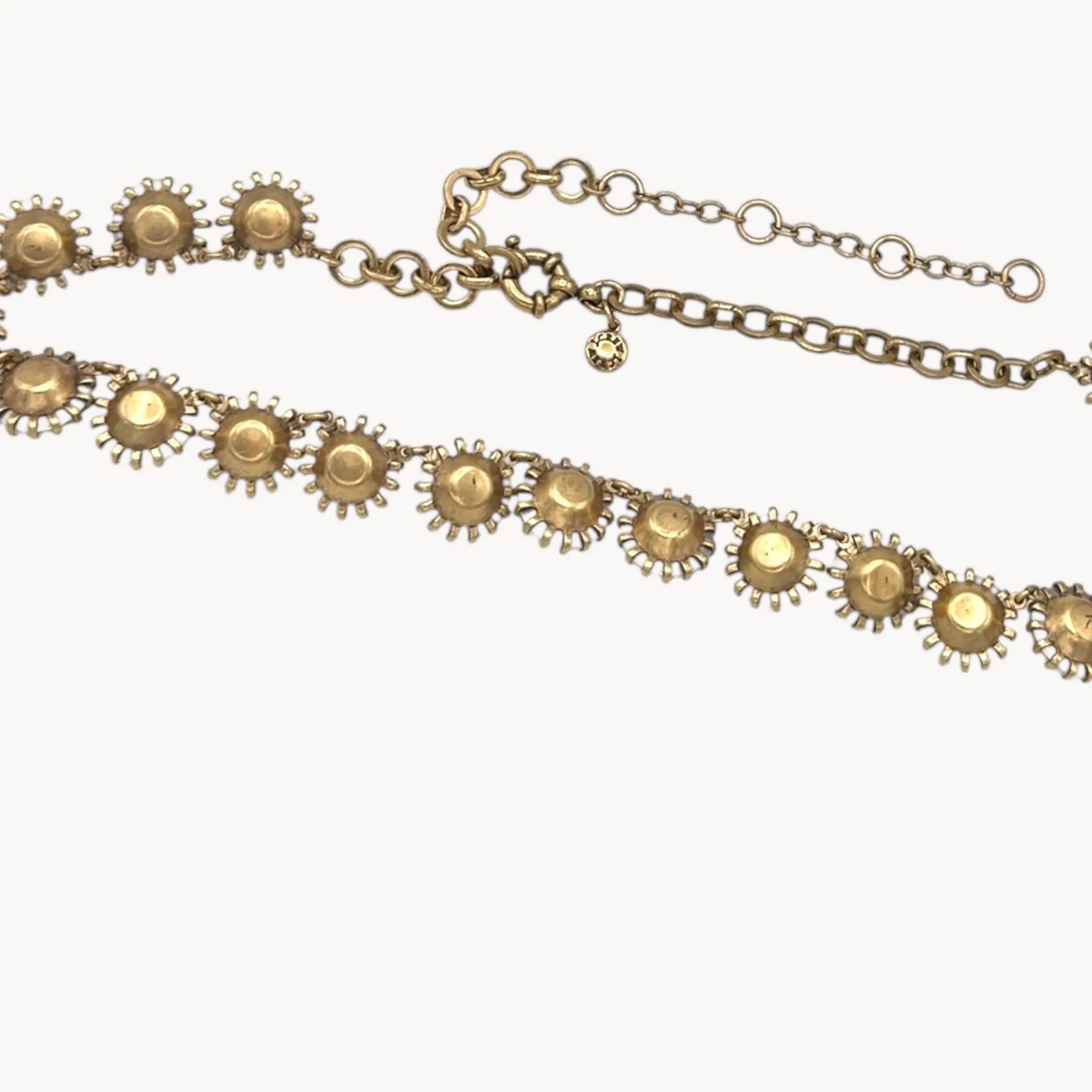 Back view of J. Crew Venus Flytrap necklace with large clear round rhinestones on white background.