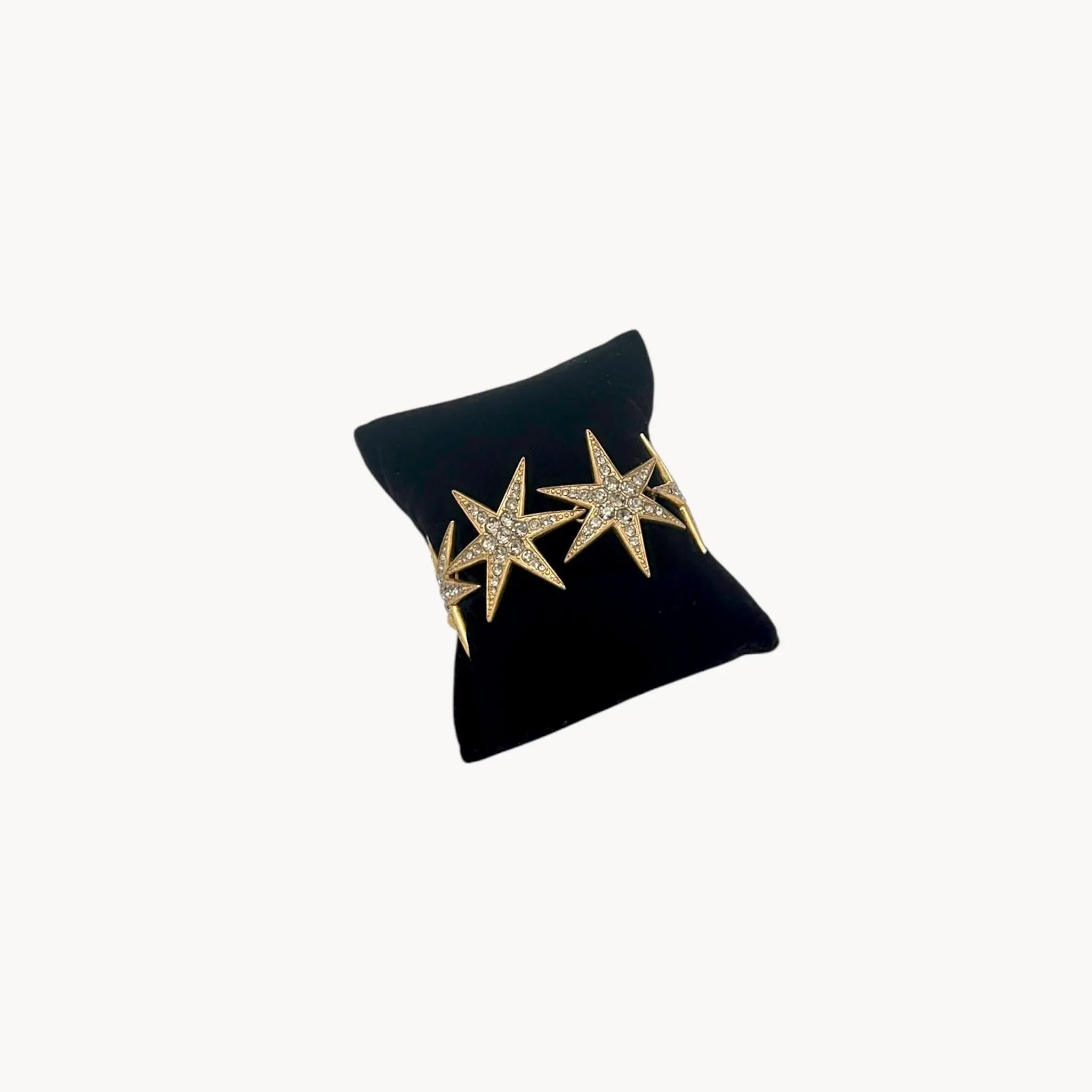 Side view of J. Crew gold-tone Art Deco style star bracelet with crystal accents.