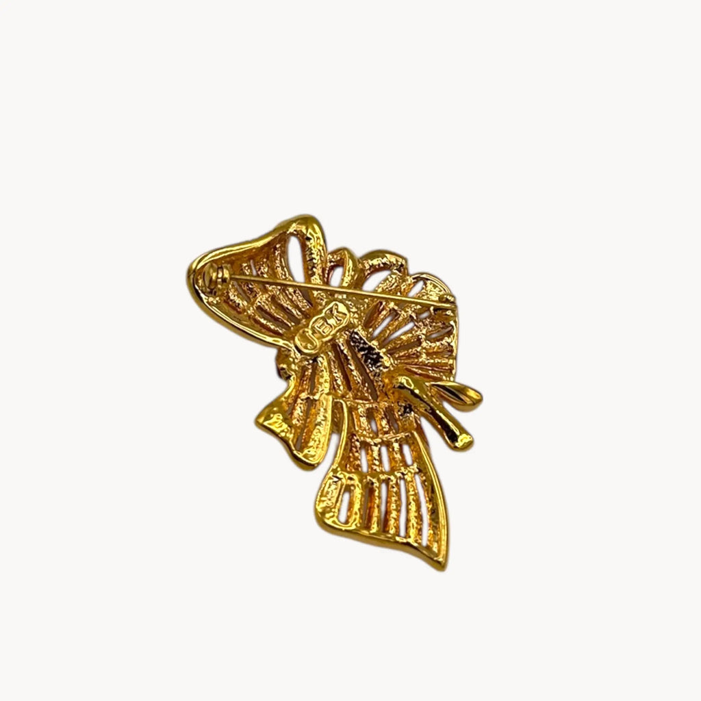 Back view of Jacqueline Bouvier Kennedy Camrose & Kross gold bow brooch with crystals and red rhinestones.