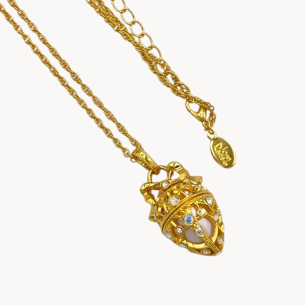 Close up of pendant of Joan Rivers gold egg locket necklace on long chain