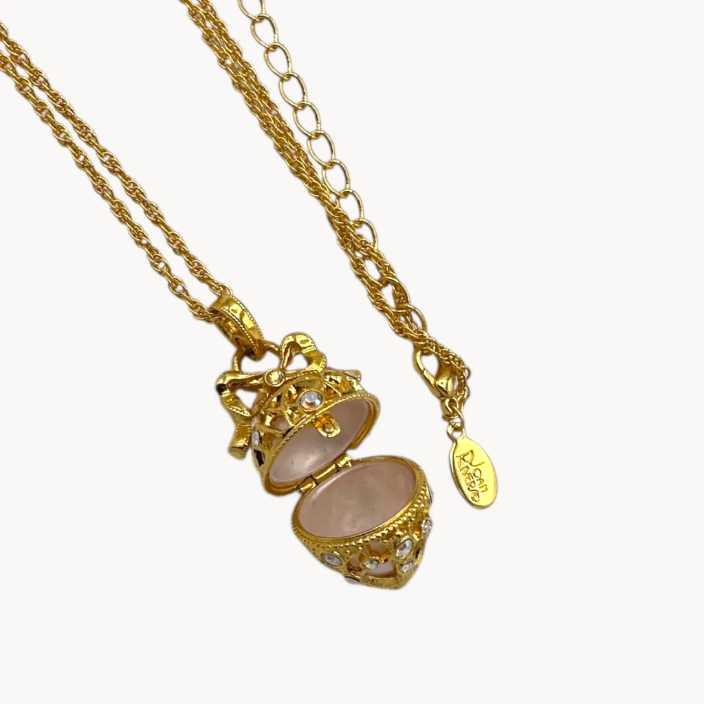 Open locket of Joan Rivers gold egg locket necklace on long chain