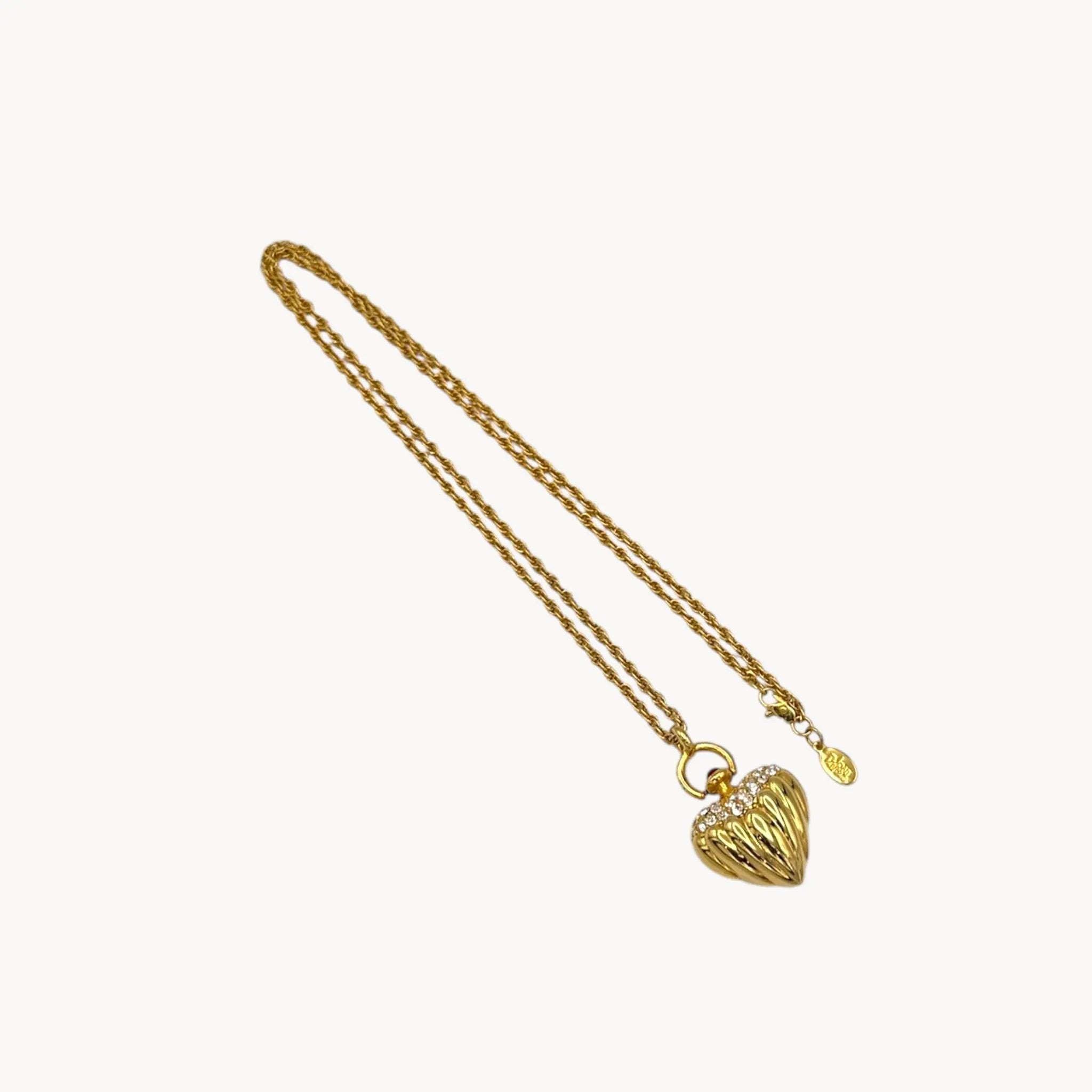 Reverse side of Joan Rivers gold heart pendant necklace with crystal accents on chain, vintage 1990s statement jewelry.