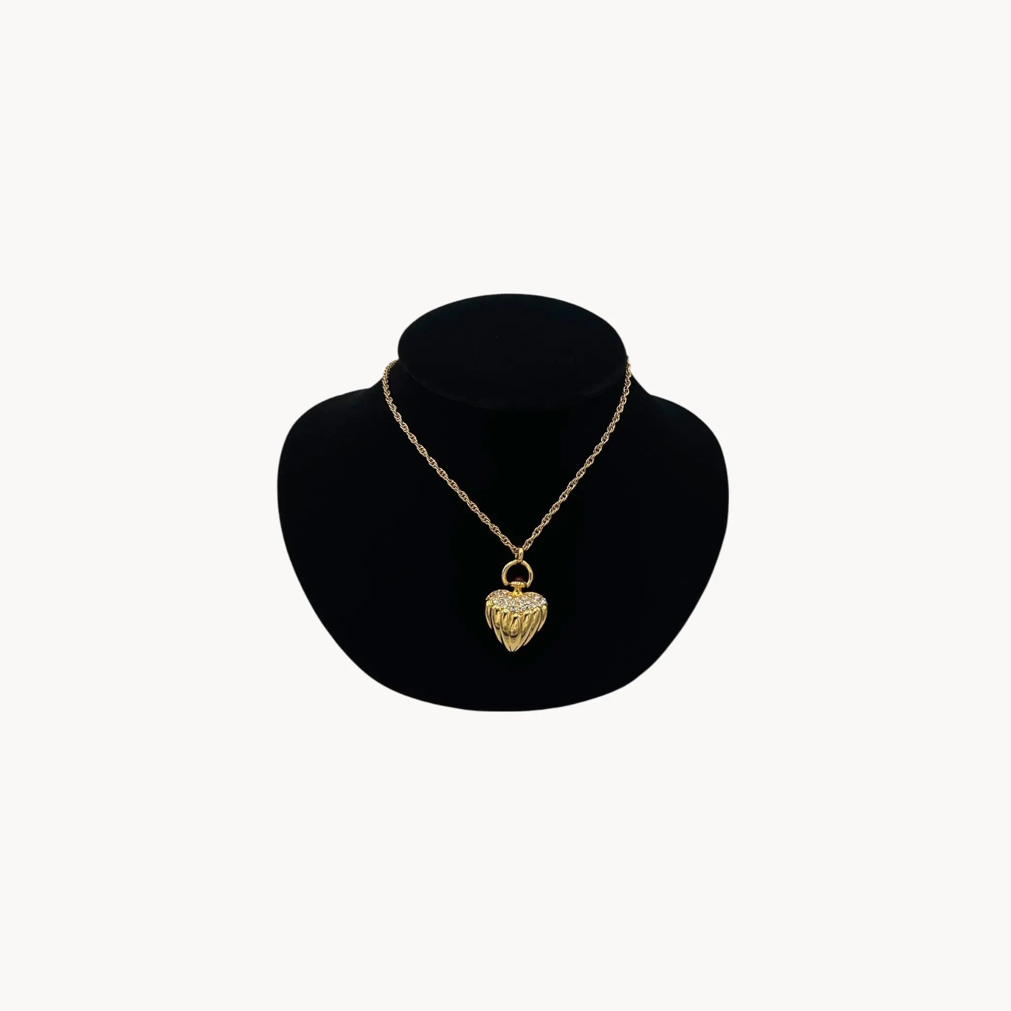 Joan Rivers gold heart pendant necklace with crystal accents on chain, vintage 1990s statement jewelry.