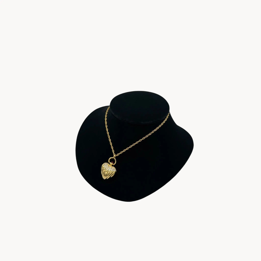 Side view of Joan Rivers gold heart pendant necklace with crystal accents on chain, vintage 1990s statement jewelry.