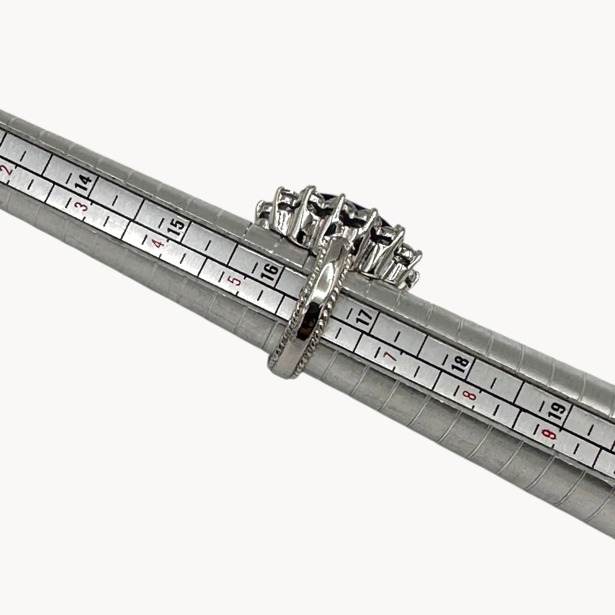 Size view of Kenneth Jay Lane blue oval crystal cocktail ring inspired by Princess Diana’s sapphire engagement ring on white background.