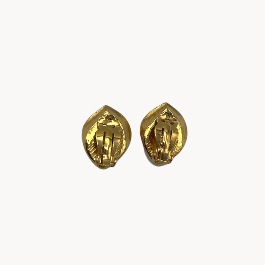 Back view of Kenneth Jay Lane for Avon white enamel rose clip-on earrings with gold and crystal accents