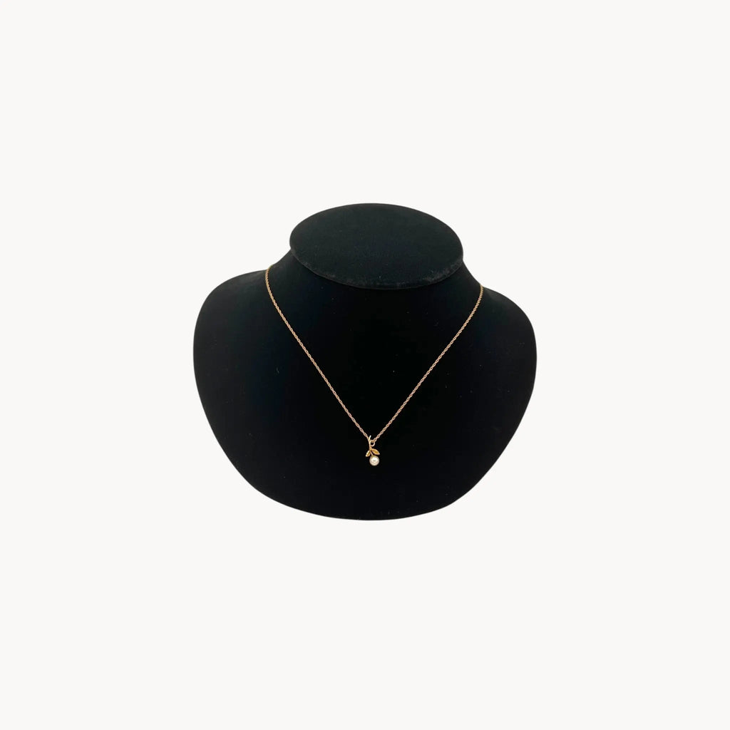 Krementz dainty gold flower pendant necklace with pearl center.