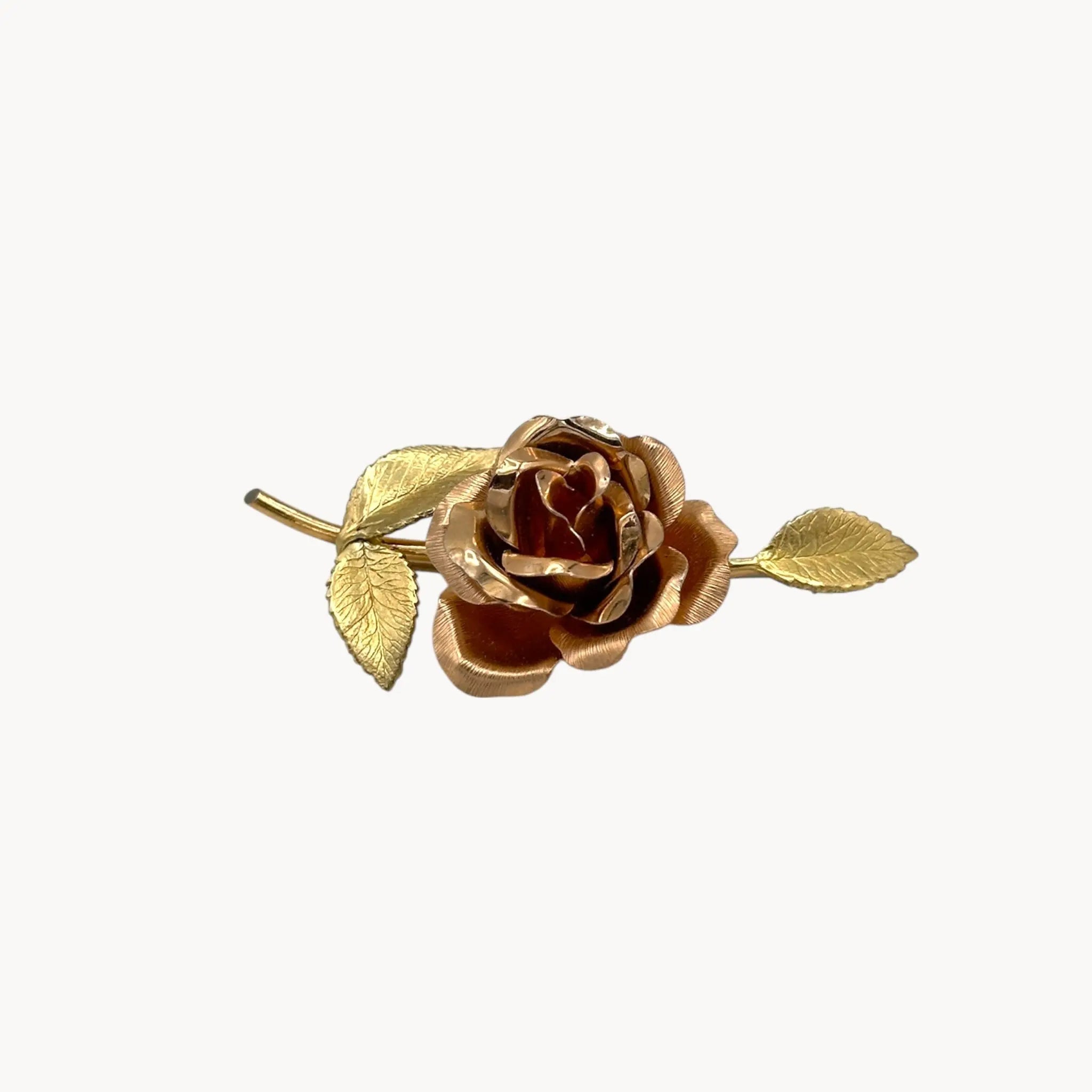 Side view of Vintage Krementz gold rose flower brooch with textured leaves.