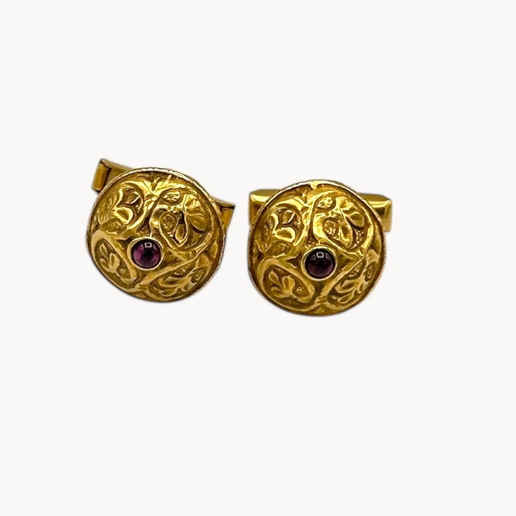 Vintage MMA gold embossed cufflinks with cabochon centers displayed on white background.