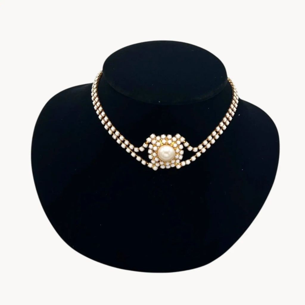Close up view on bust of Mid-century milk glass rhinestone bridal choker necklace with central pearl medallion.