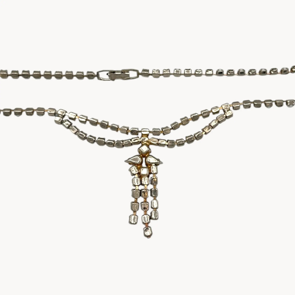 Back view of Vintage mid-century rhinestone and milk glass draped necklace with pendant drop.