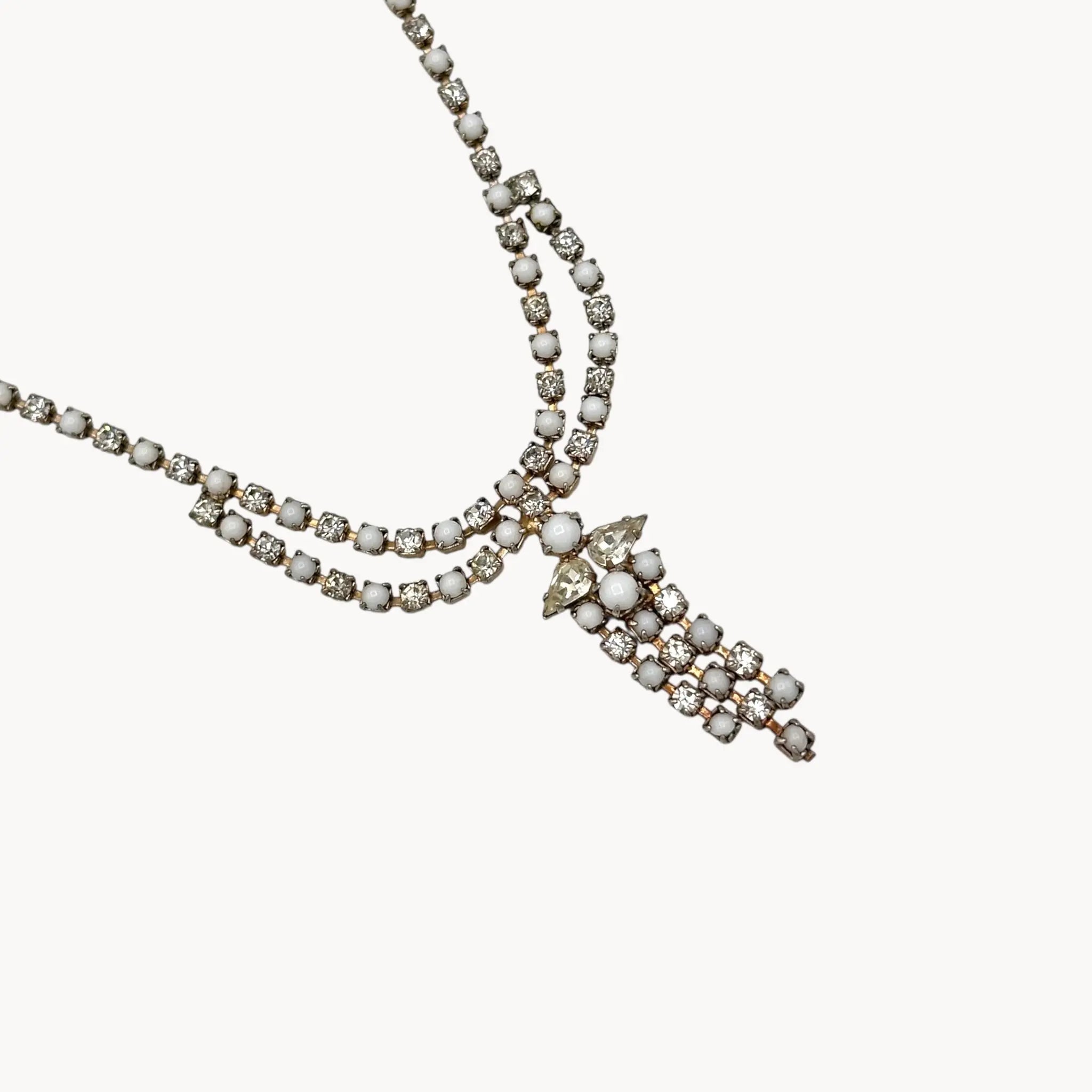 Close up of pendant of Vintage mid-century rhinestone and milk glass draped necklace with pendant drop.