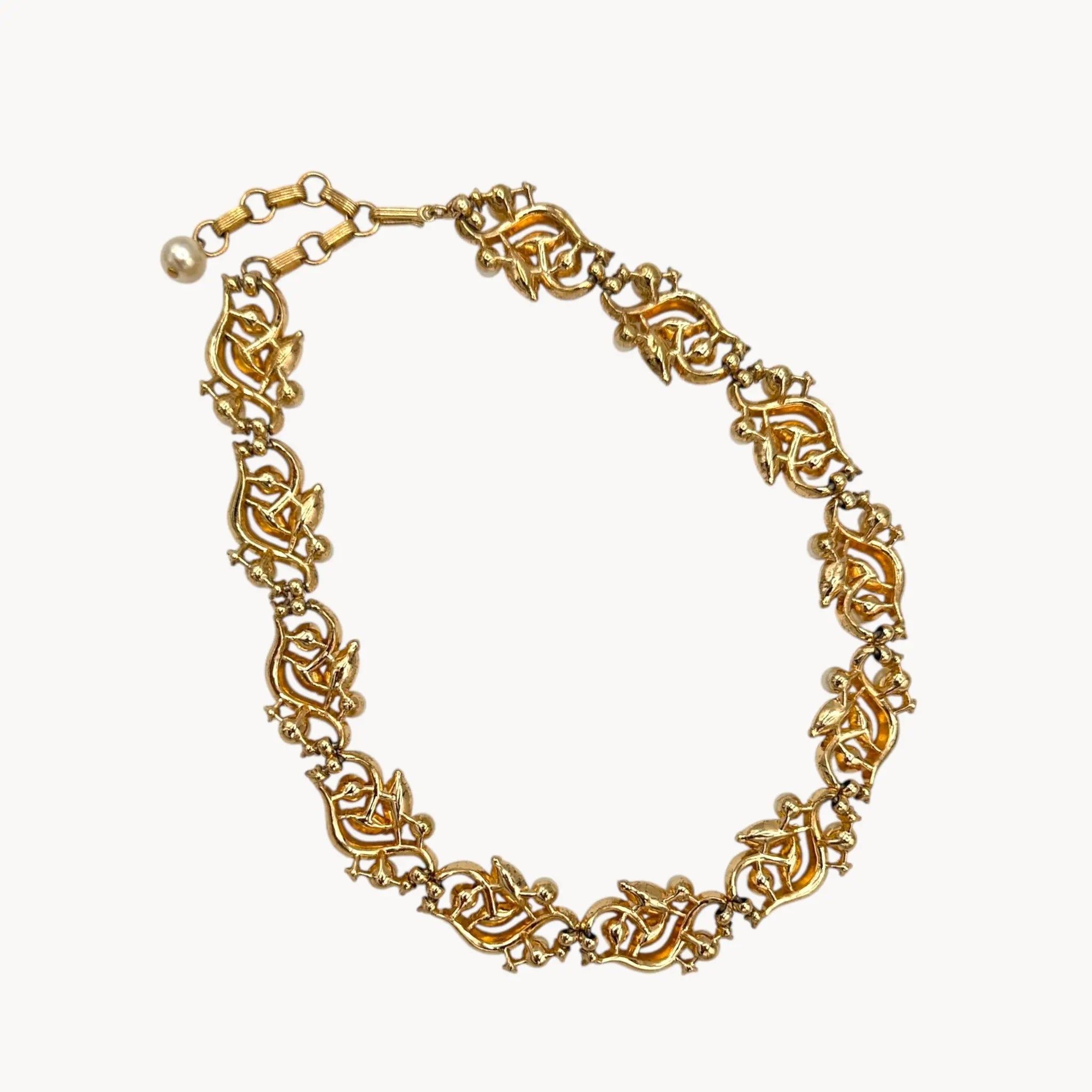 Back view of Midcentury gold floral rhinestone necklace with faux pearls.