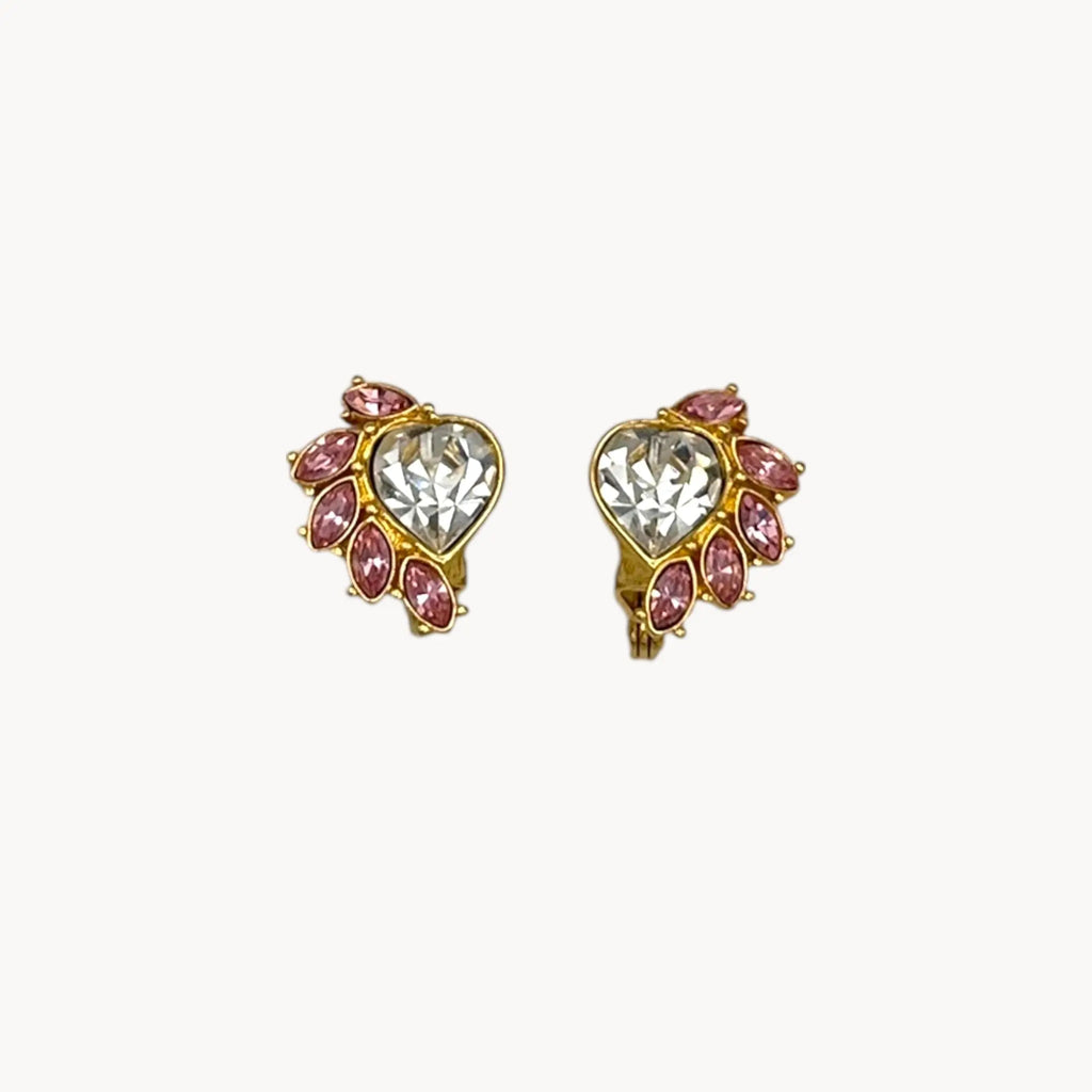 Close up of earrings of Vintage Monet gold necklace and clip-on earring set with clear heart and pink rhinestones.