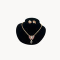 Vintage Monet gold necklace and clip-on earring set with clear heart and pink rhinestones.