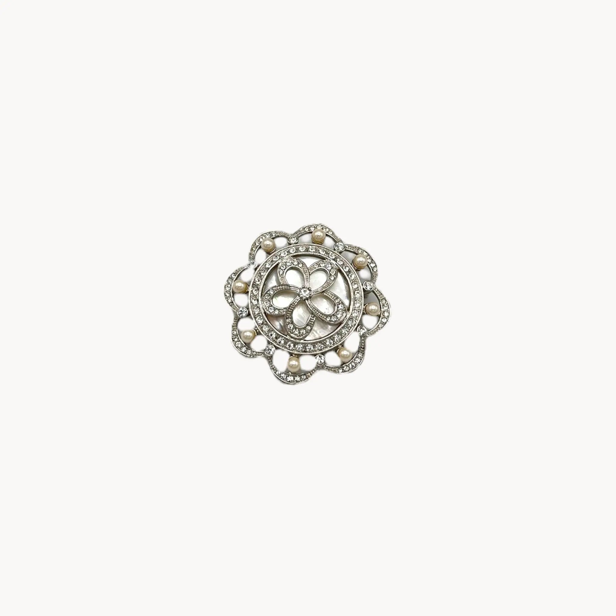 Monet vintage silver tone brooch with rhinestones and faux pearls in floral design, elegant bridal jewelry piece on white background.
