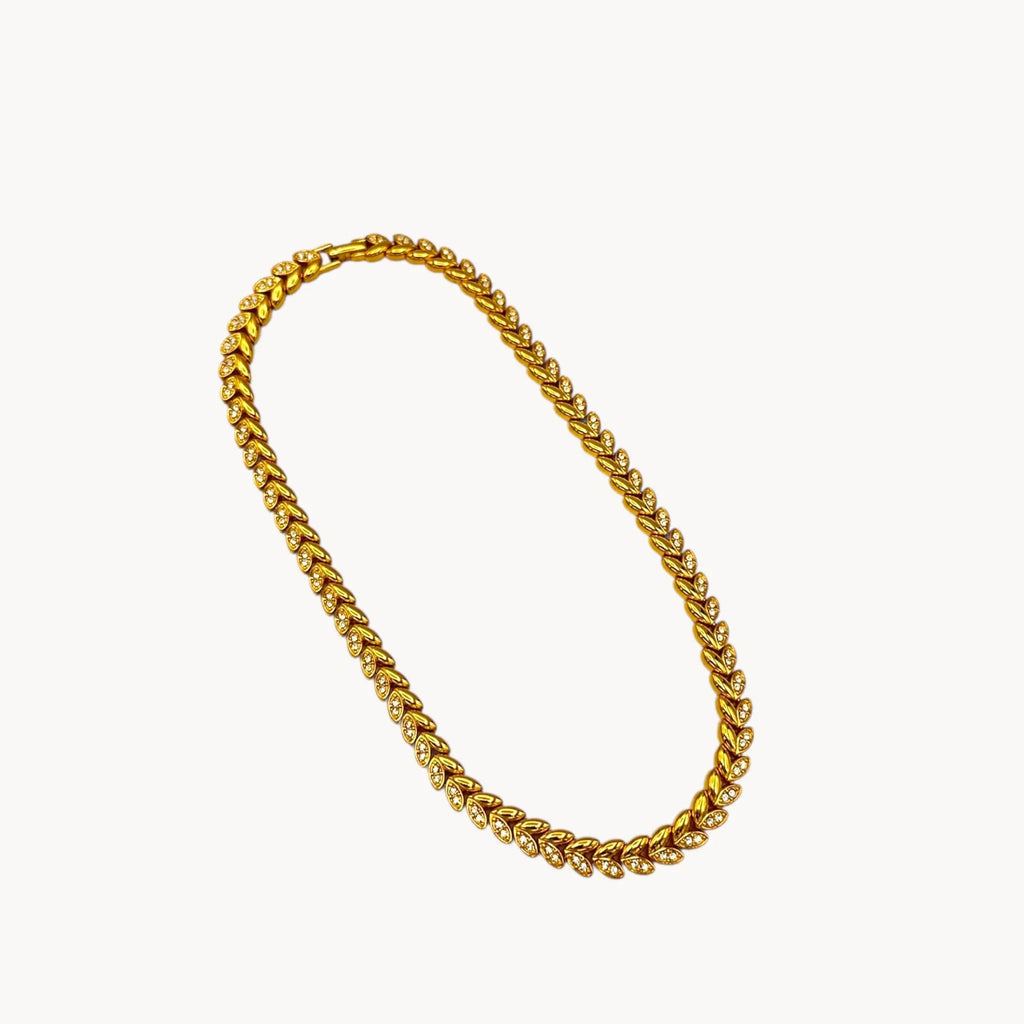 On white background Avon vintage gold link rhinestone necklace, classic 1980s–1990s bridal and evening jewelry.