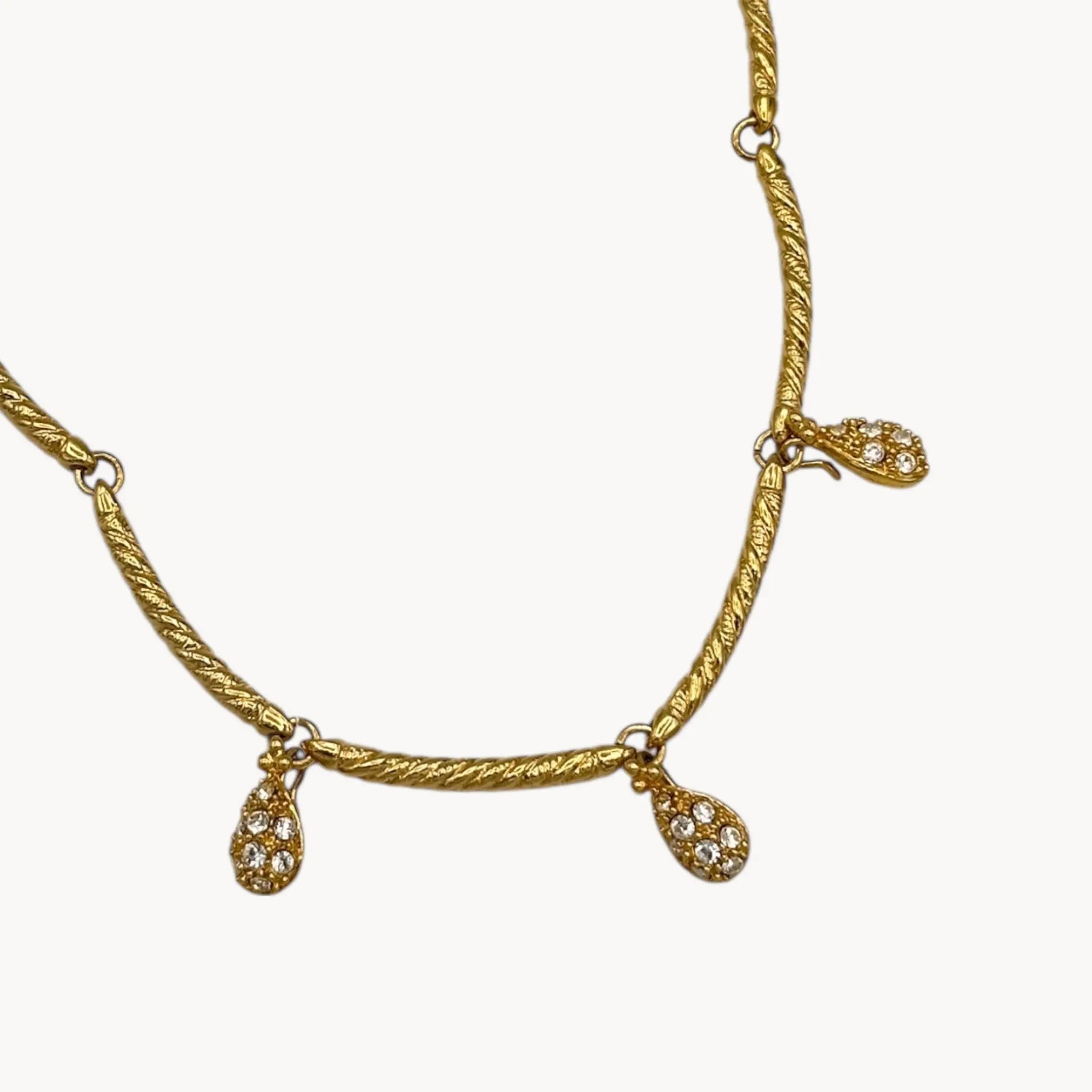 Close up of dangles of Nolan Miller gold adjustable necklace with removable rhinestone teardrop dangles, vintage bridal jewelry.