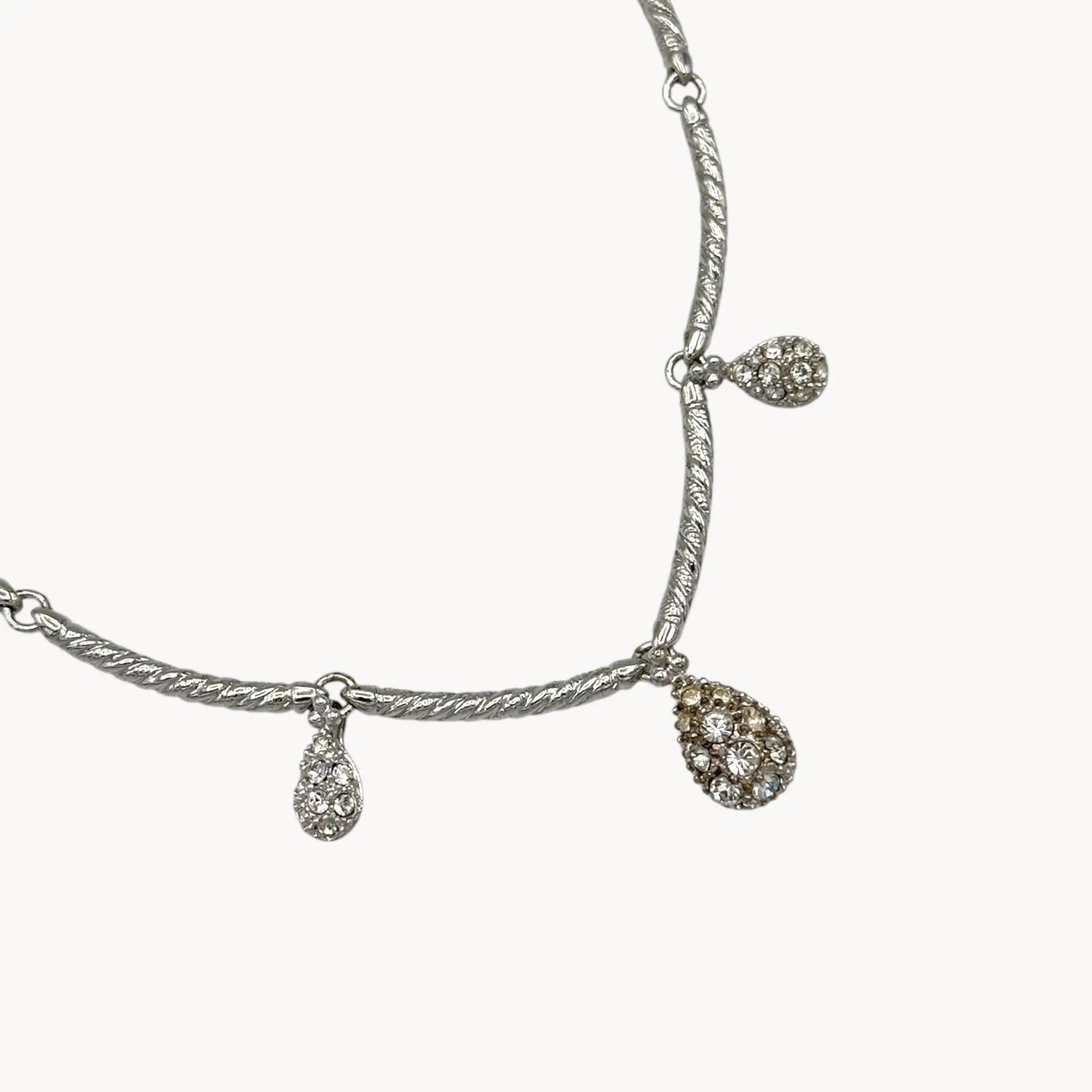Close up of dangles of Nolan Miller silver adjustable necklace with removable rhinestone teardrop dangles, vintage bridal jewelry.