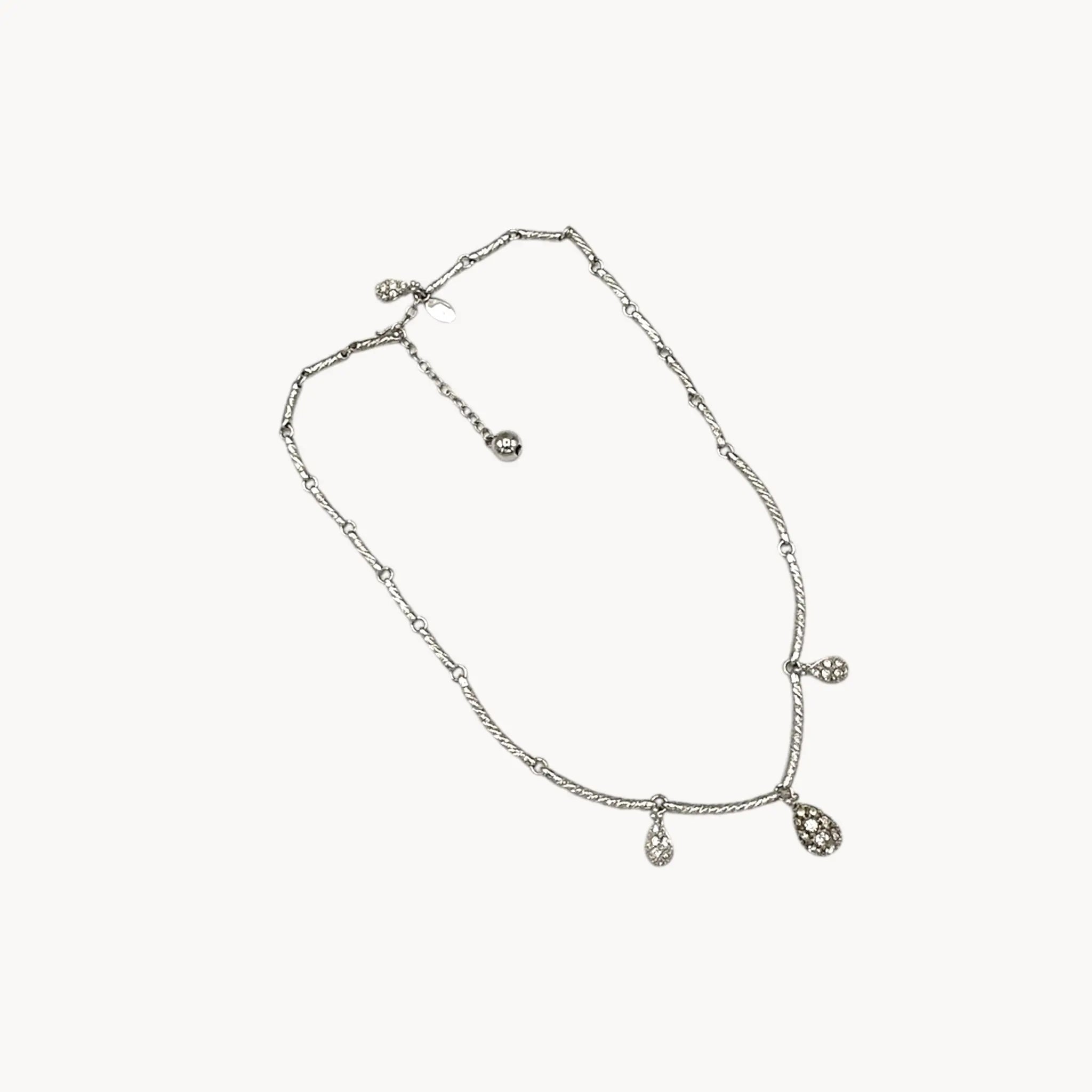 On white background Nolan Miller silver adjustable necklace with removable rhinestone teardrop dangles, vintage bridal jewelry.