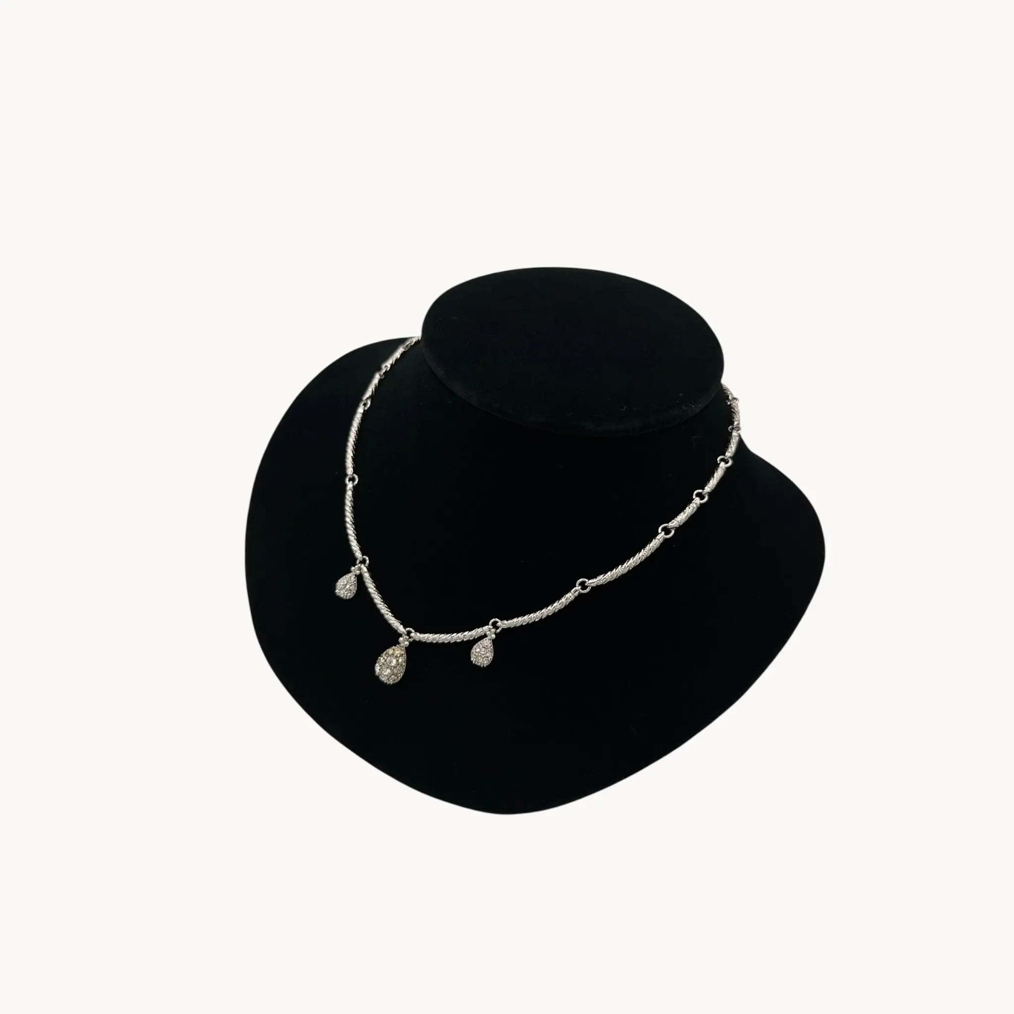 Side view of Nolan Miller silver adjustable necklace with removable rhinestone teardrop dangles, vintage bridal jewelry.