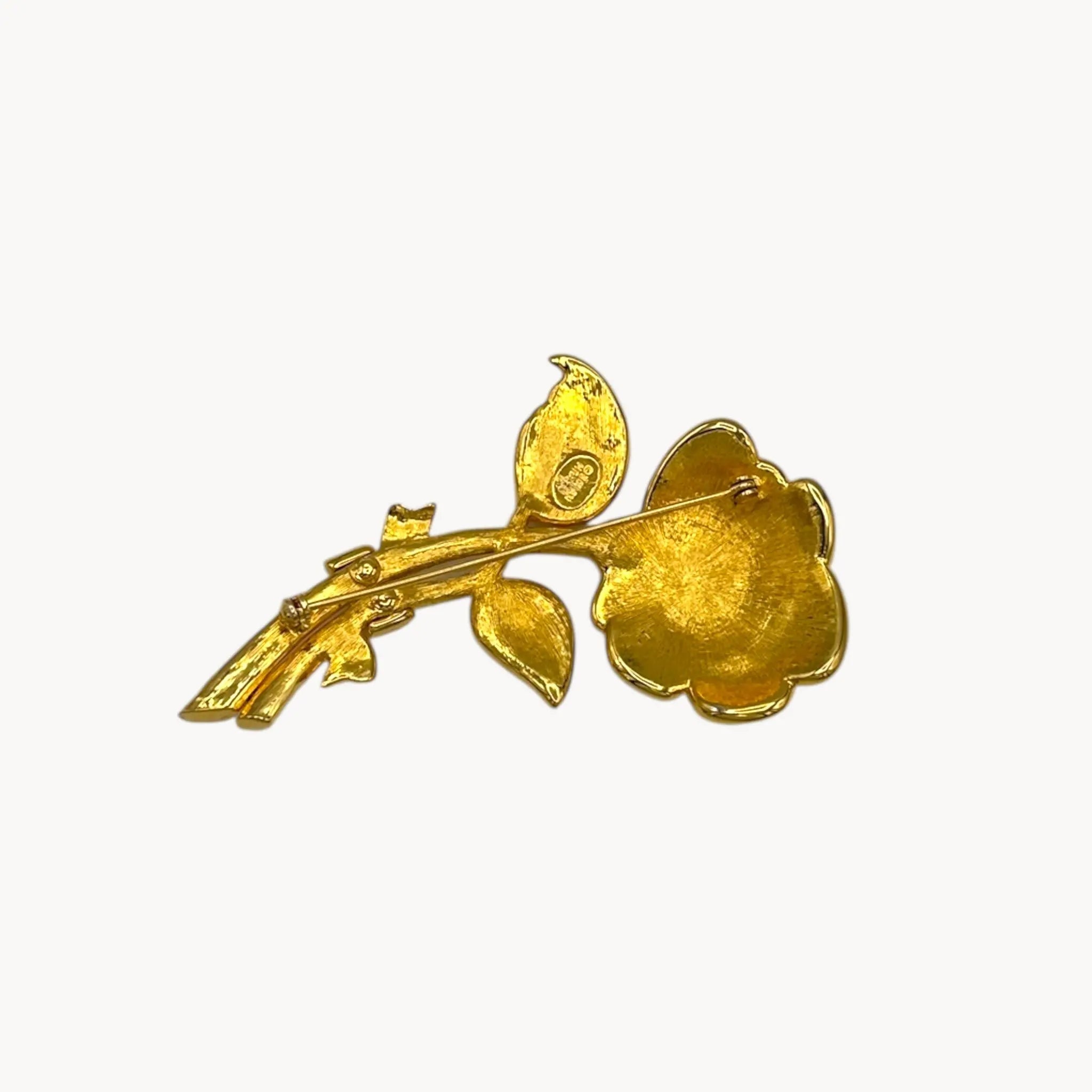 Back view of Nolan Miller gold and rhinestone flower brooch with pavé crystal accents