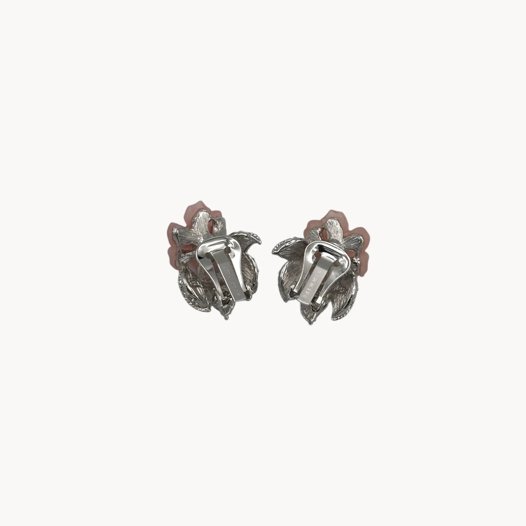 Back view of Nolan Miller vintage pink flower clip-on earrings with rhinestone accents and silver-tone leaves
