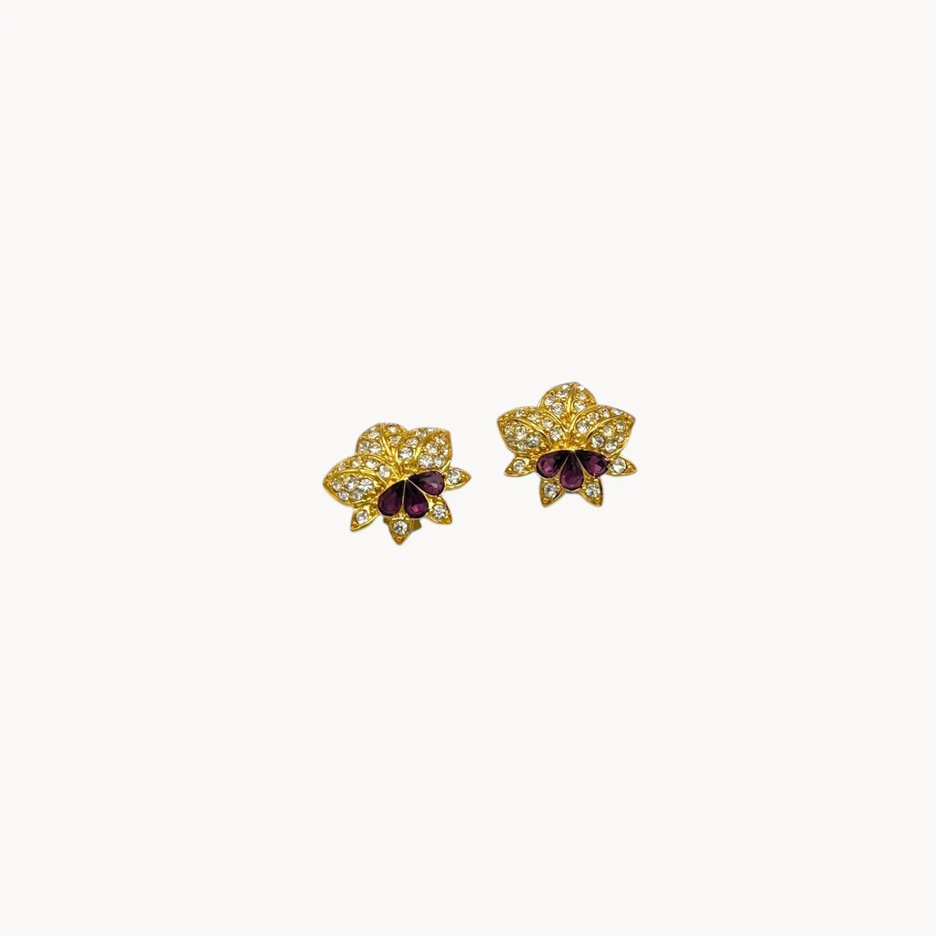 Nolan Miller vintage flower clip-on earrings with clear and amethyst rhinestones accents in gold-tone metal.
