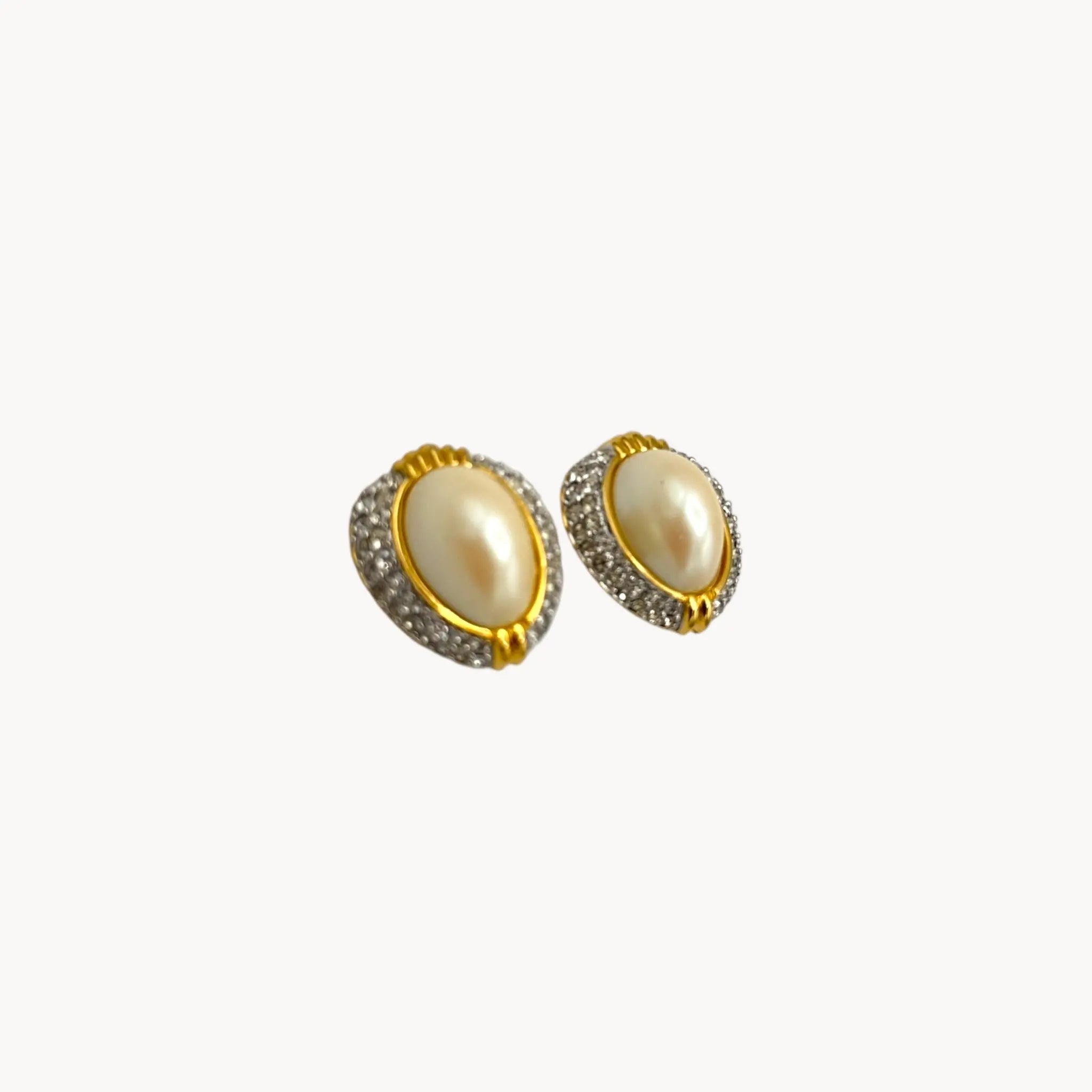 Side view of Richelieu gold-tone faux pearl clip-on earrings with rhinestone accents, vintage jewelry on white background.