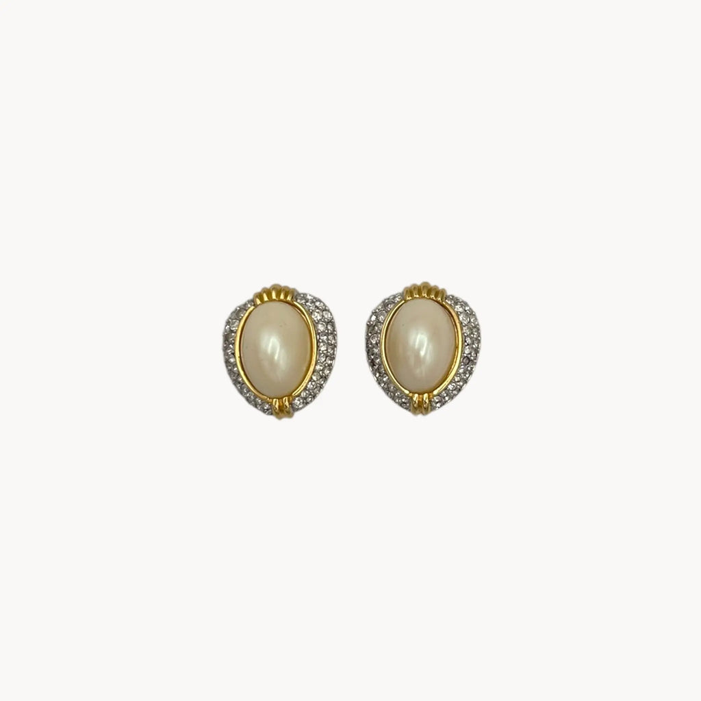 Close up view of Richelieu gold-tone faux pearl clip-on earrings with rhinestone accents, vintage jewelry on white background.