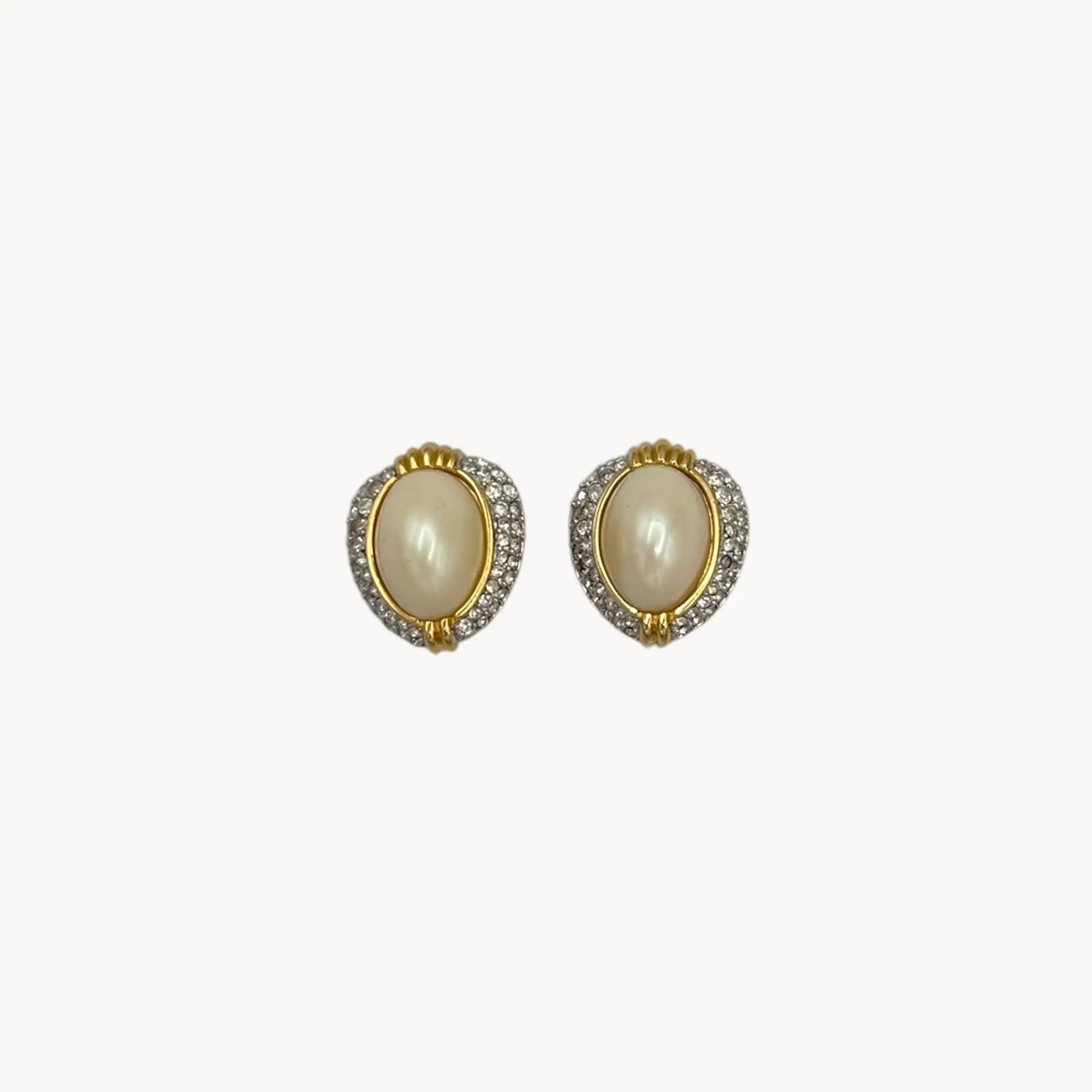 Close up view of Richelieu gold-tone faux pearl clip-on earrings with rhinestone accents, vintage jewelry on white background.